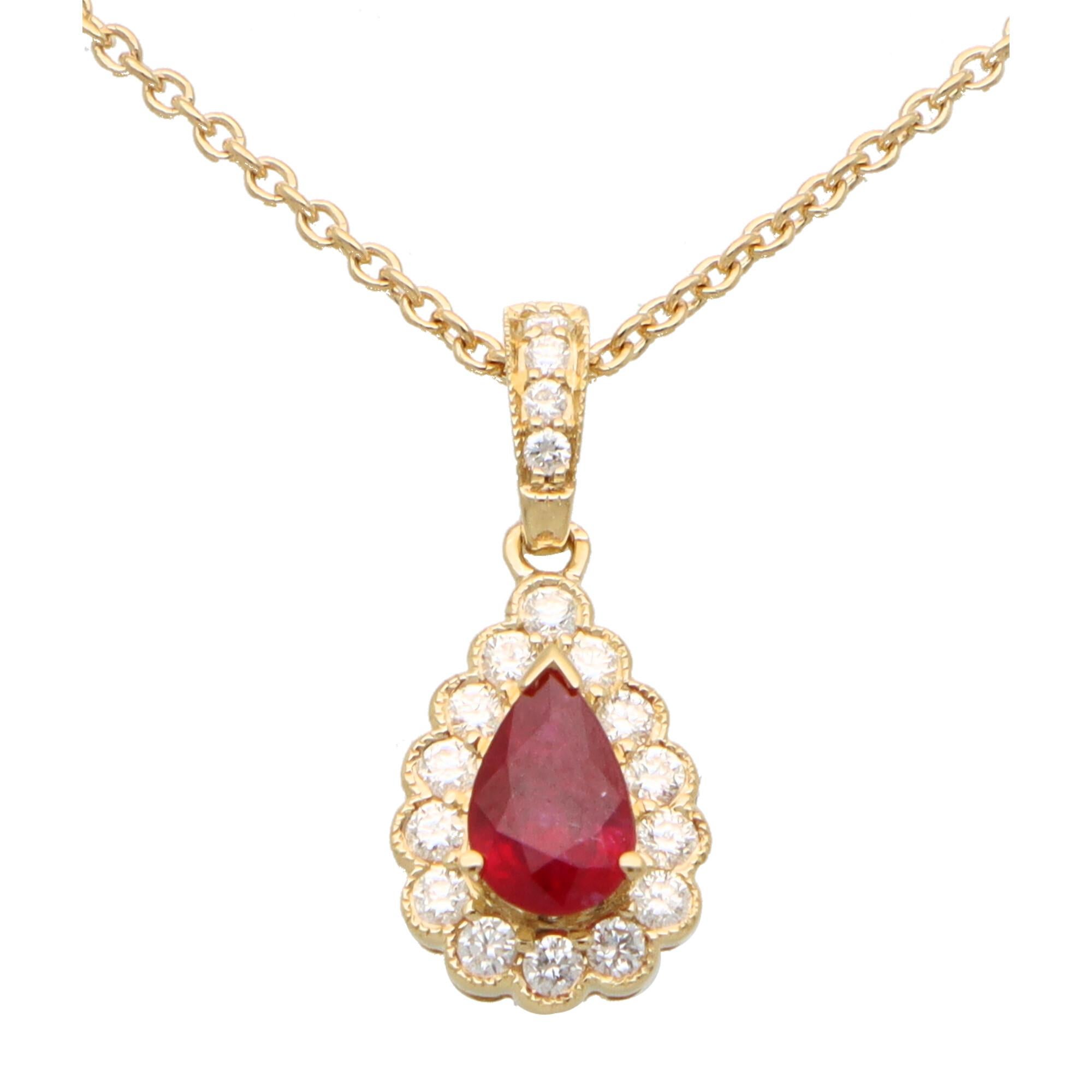  A beautiful little ruby and diamond cluster pendant set in 18k yellow gold.

The pendant is centrally set with a beautiful colored red pear cut ruby which is surrounded by 14 sparkly round brilliant cut diamonds. The pendant hangs from a diamond