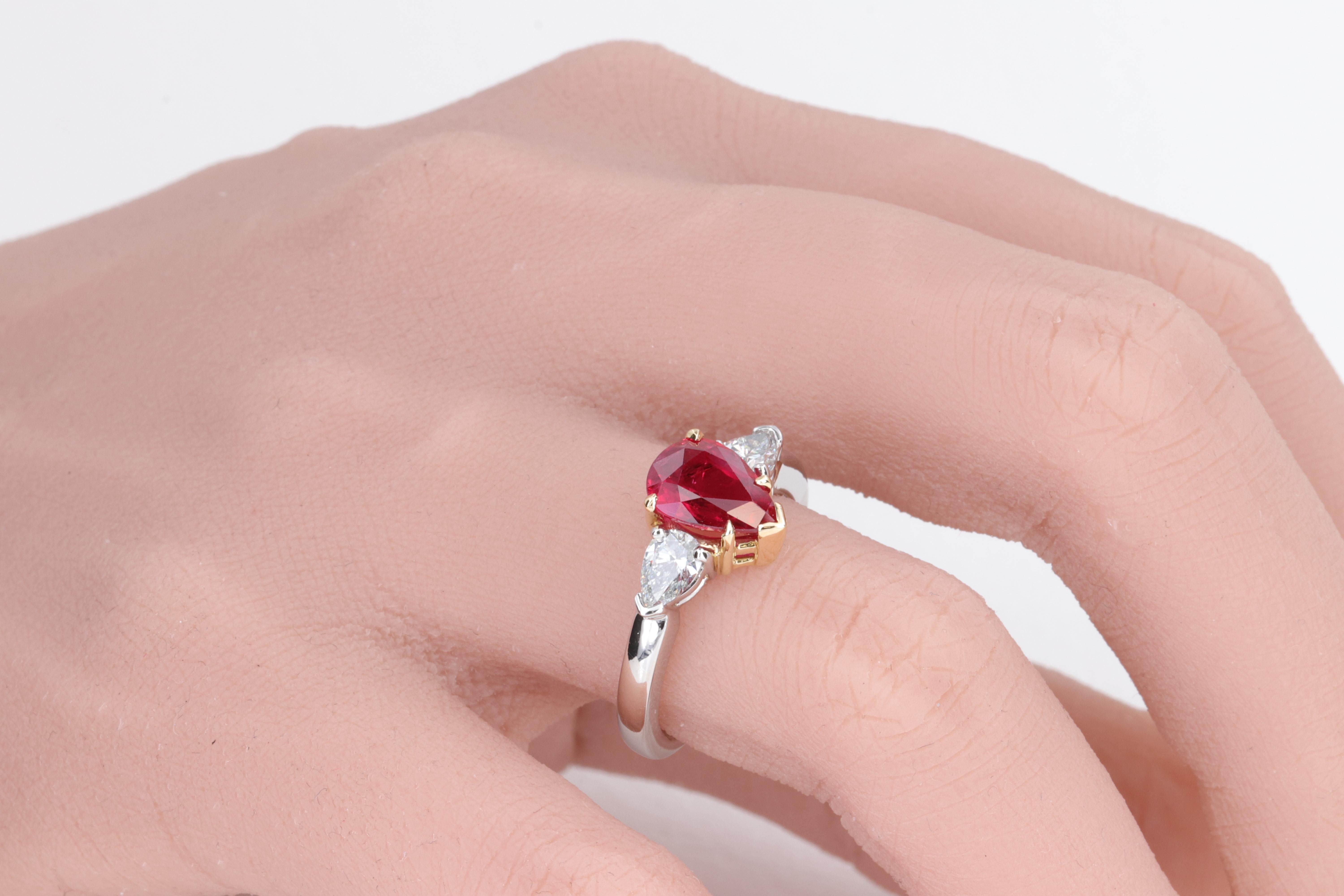 Ruby and Diamond Pear Shape GIA 3 Stone Ring in Platinum and Yellow Gold

A beautifully made classic three stone ring set with a 1.99 carat vivid red pear shape ruby center stone accompanied by a GIA report, and 2 pear shape diamond side stones