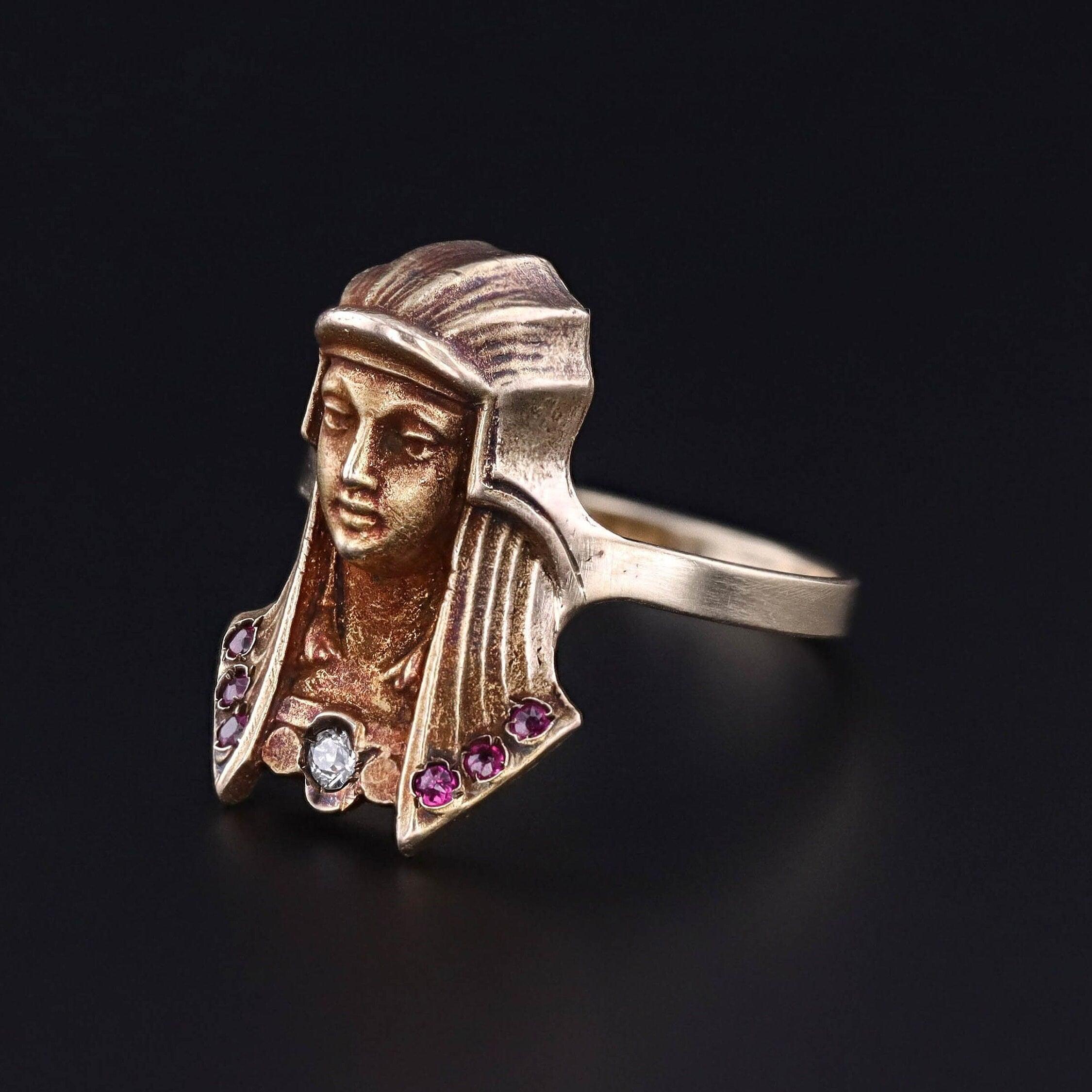 Behold the captivating allure of our Pharaoh-inspired ring, meticulously crafted from 14k gold and adorned with rubies and a single old European cut diamond accent. Originally dating back to circa 1900 as an antique stickpin, our skilled jeweler has