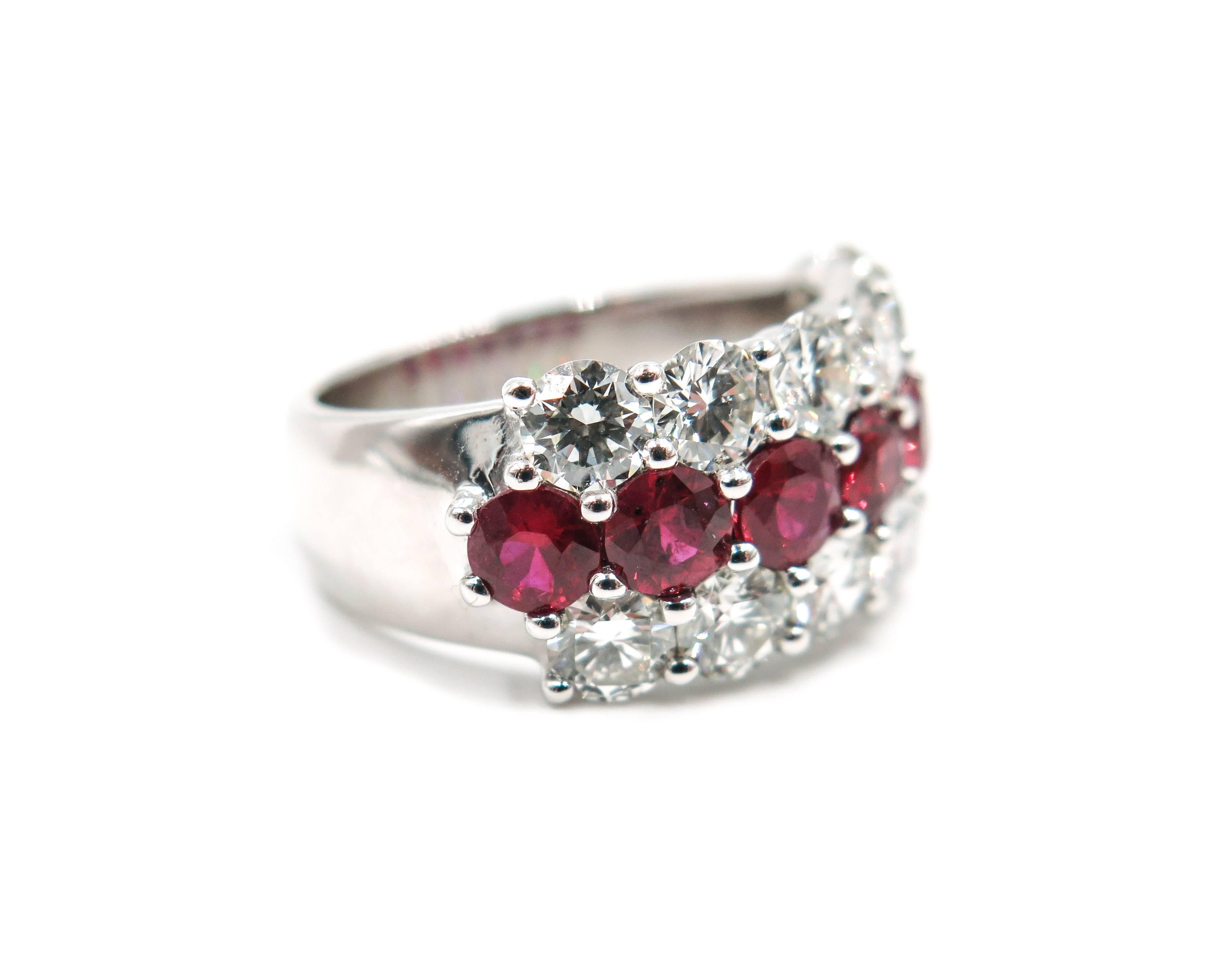 This magnificent ruby and diamond ring features 3 rows of mesmerizing brilliance.
Handcrafted in Platinum and set with 12 round brilliant cut diamonds weighing 2.45 carats total, G/H color, VS clarity. Further accenting the diamonds are 7 round cut