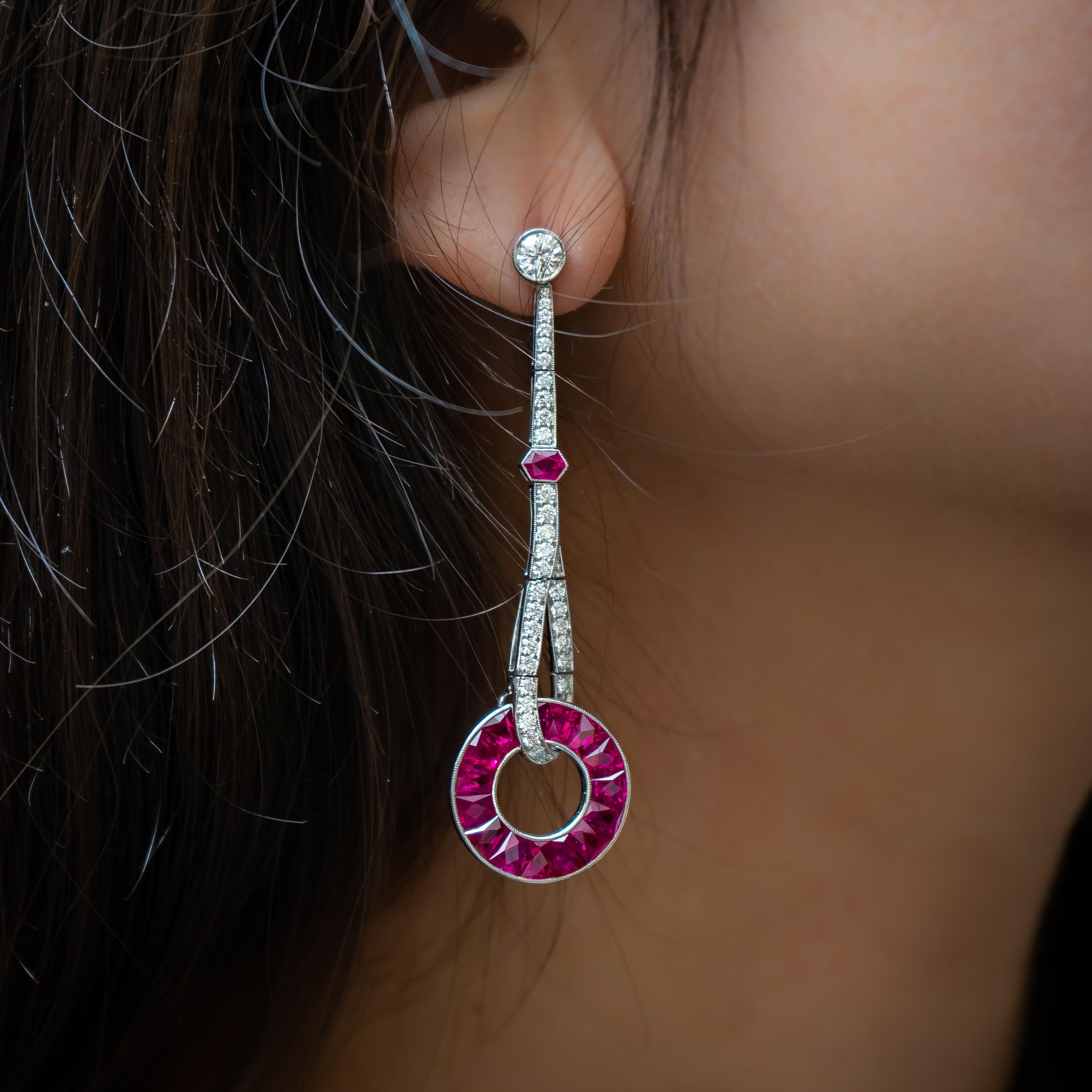 A pair of ruby and diamond drop earrings, set with round brilliant-cut diamonds, with two at the top, weighing a total of 0.68ct, the drop is set with a total of 0.90ct, with two, hexagonal, rubies, with a circle set with French-cut rubies, with a