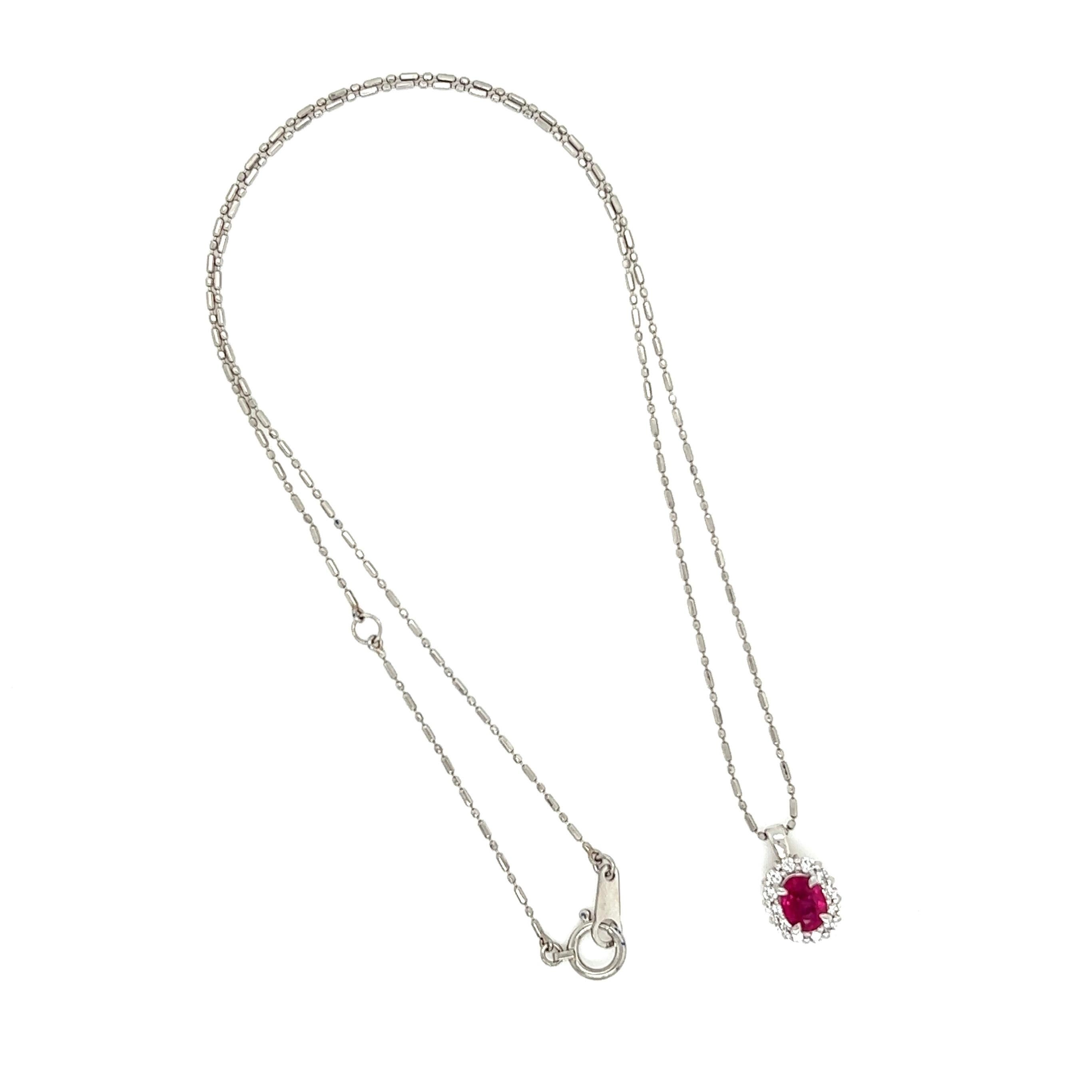 Simply Beautiful! Solitaire Ruby and Diamond Halo Necklace. Center securely Hand set with an Oval Ruby approx. 0.61 Carat, surrounded by Diamonds, approx. 0.40tcw. Suspended on a 16