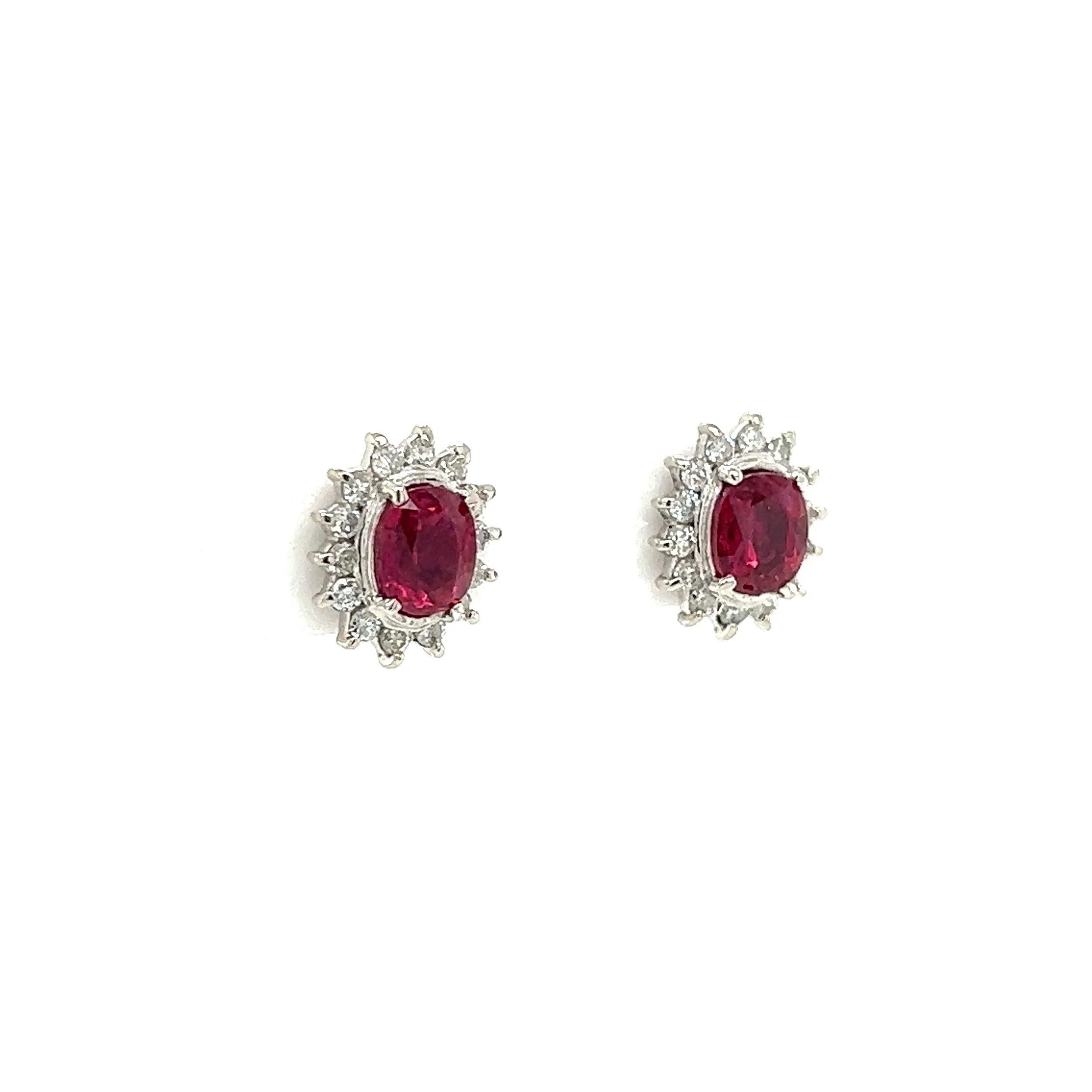 Simply Beautiful! Finely detailed Art Deco Revival 10.9mm Ruby and Diamond Platinum Stud Earrings. Each centering a securely nestled Hand set Oval Ruby, weighing 0.75ct and 0.73ct. Surrounded by Diamonds, approx. 0.40tcw. Earrings measure approx.