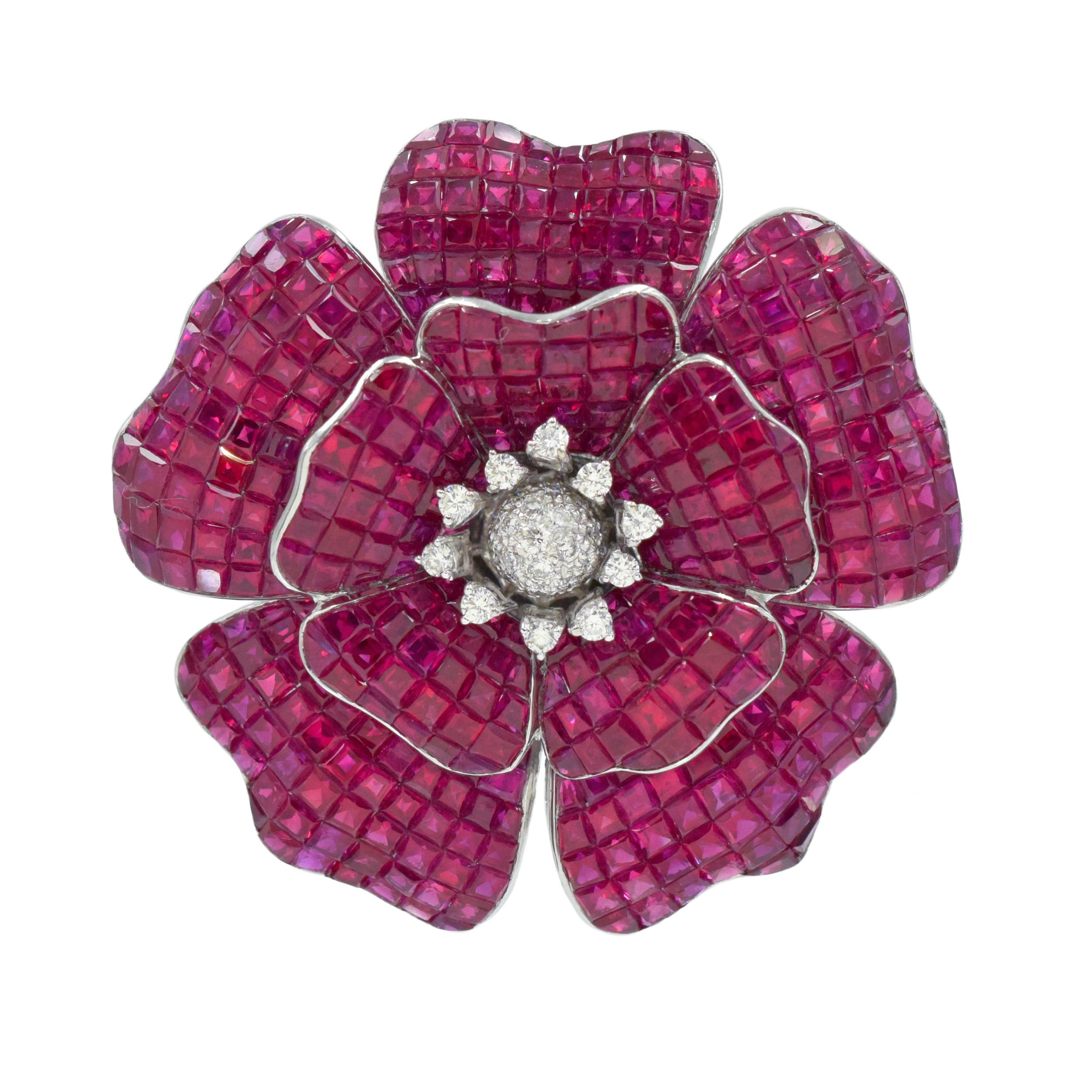 Ruby and diamond Poppy Flower brooch / pendant in 18k white gold. The brooch features poppy flower with 10 petals, each set with invisibly set square rubies with total weight of 60.15ct. Center of the flower accented with round brilliant cut