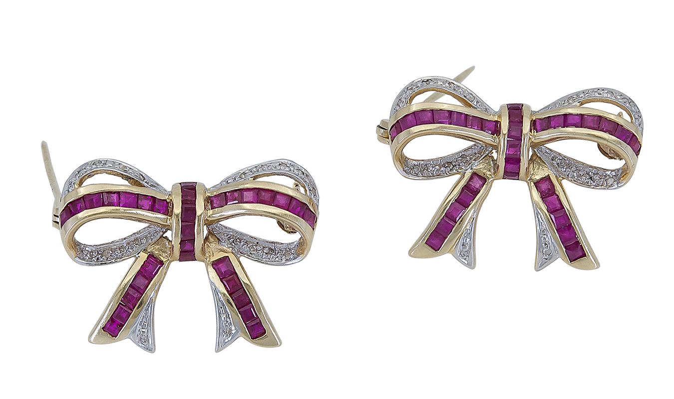 A fashionable piece of jewelry showcasing square cut rubies and round diamonds, elegantly set in a ribbon (bow) design made in 14k yellow and white gold.
Comes in a set of two.
Rubies weigh 1.80 carats total.
Diamonds weigh 0.18 carats total.
Ribbon