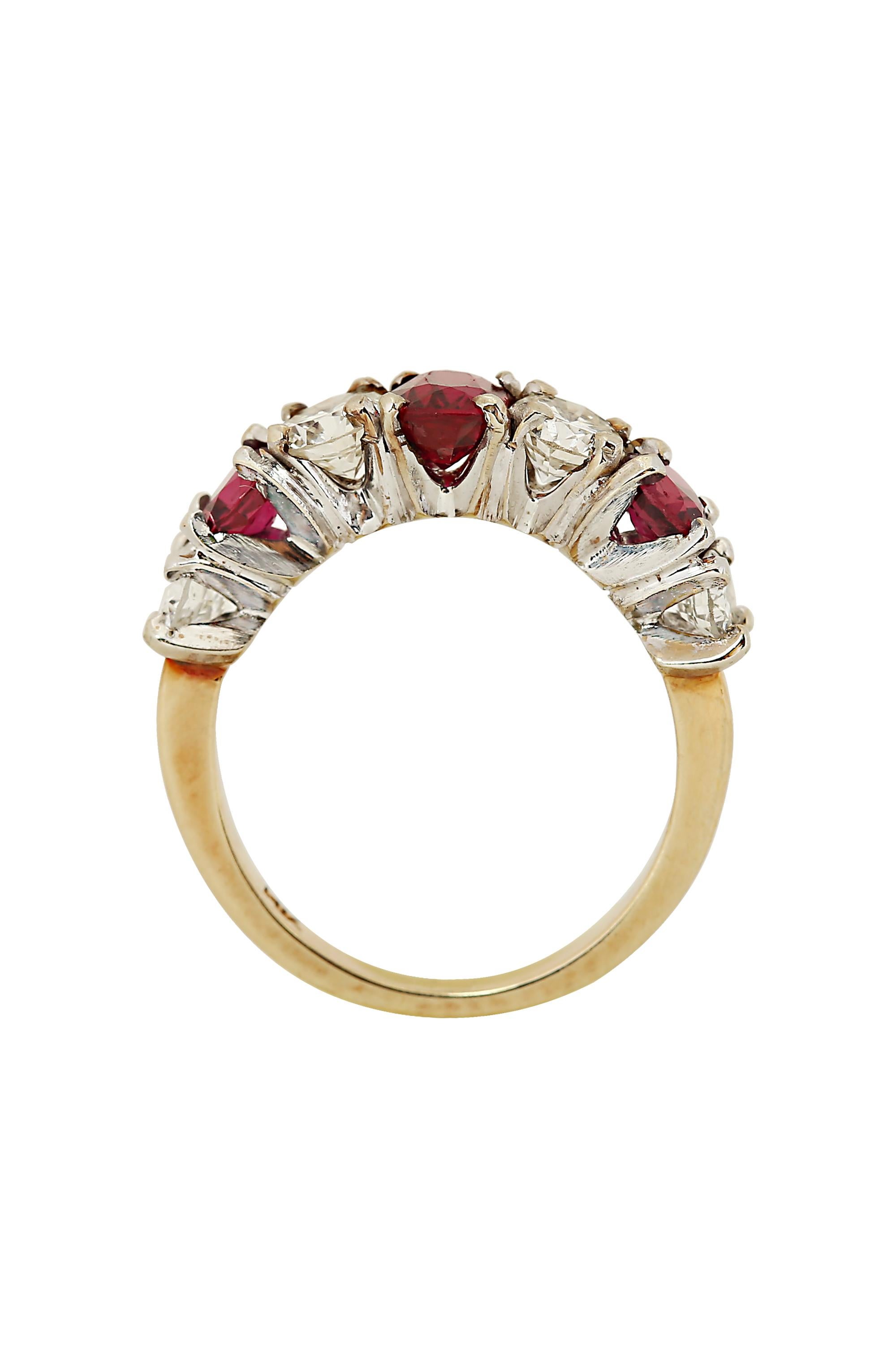 A classic study in red and white, this refined and stately ring features a radiant oval ruby center flanked on either side by alternating round diamonds and rubies. Mounted in 14 karat white and yellow gold. The ring is set with three rubies