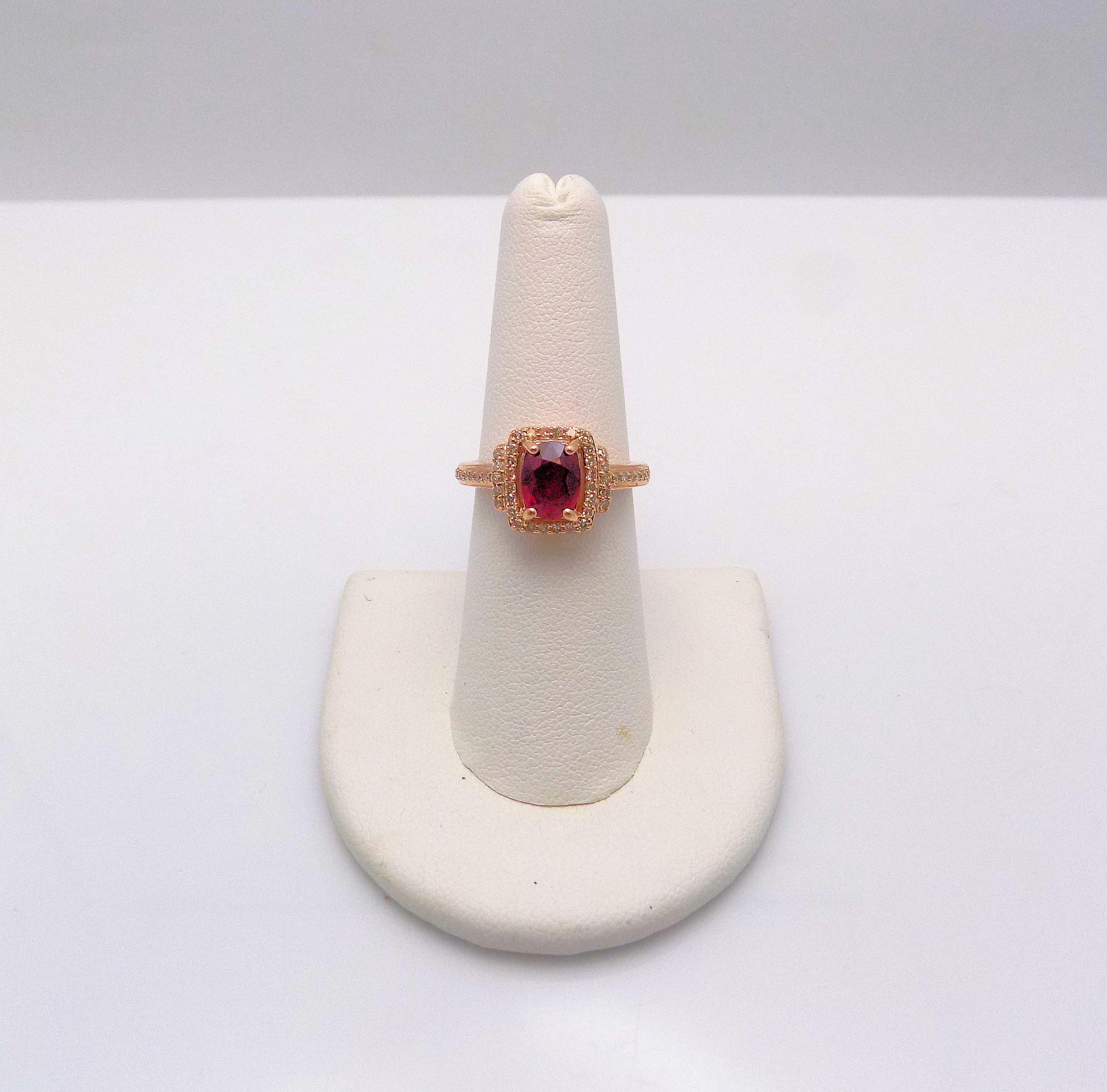 14 Karat Rose Gold Ring featuring 1 Oval Ruby 1.25 Carat; 48 Single Cut 0.25 Carat Total Weight, SI, H-I; Ring Size/Finger Size 7; 2.3 DWT or 3.58 Grams.