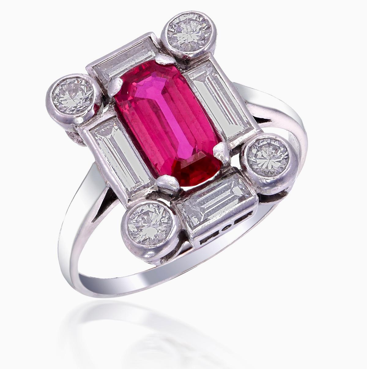Introducing a brand new ruby and diamond ring. This ring has been inspired by traditional Art Deco themes through it's symmetrical designs and traditional shaped such as rounds, baguettes, and cushions.

The center stone is a 1.34-carat Burmese