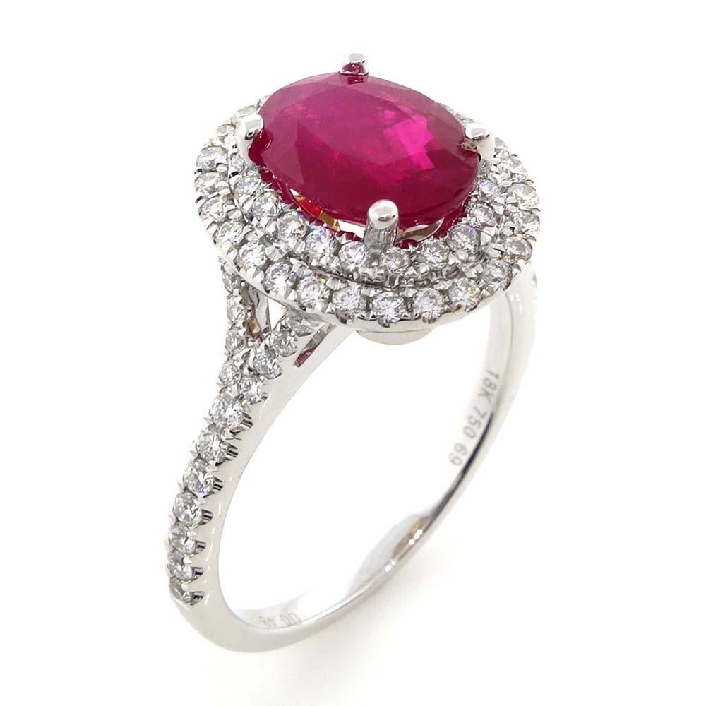 One fine round ruby of about 1.69 carats measuring 8.31X6.32X3.22mm. The ruby is surrounded by 76 Round Brilliant cut Diamonds of about 0.49 carats with a clarity of SI and color G. All stones are set in 18k white gold.

Ring Size: 6.5
Report: GIA