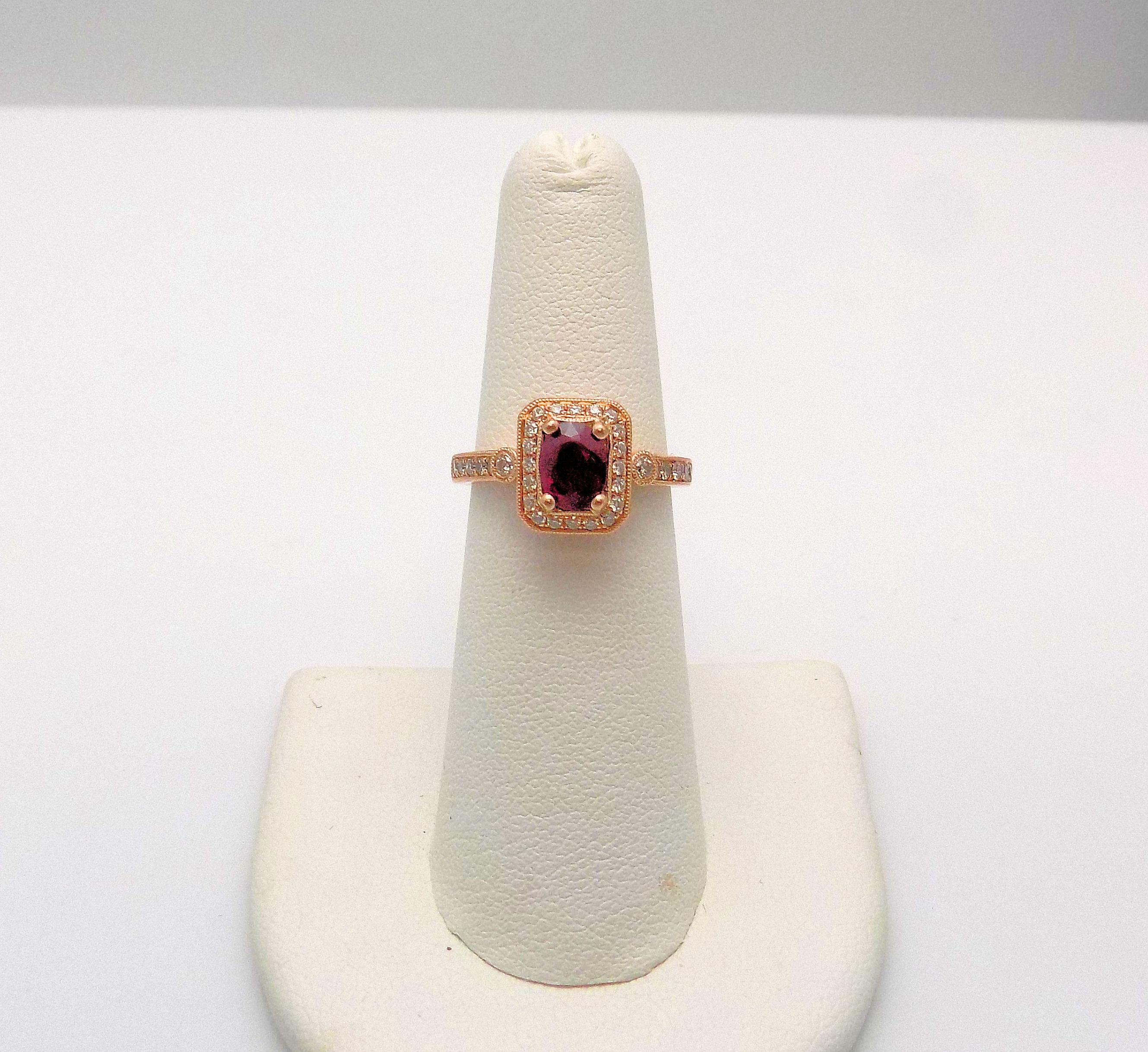 14 Karat Rose Gold Ring featuring 1 Oval Ruby 0.70 Carat; 32 Round Brilliant Diamonds 0.25 Carat Total Weight, SI, H; Ring Size/Finger Size 6; 2.7 DWT or 4.20 Grams.
