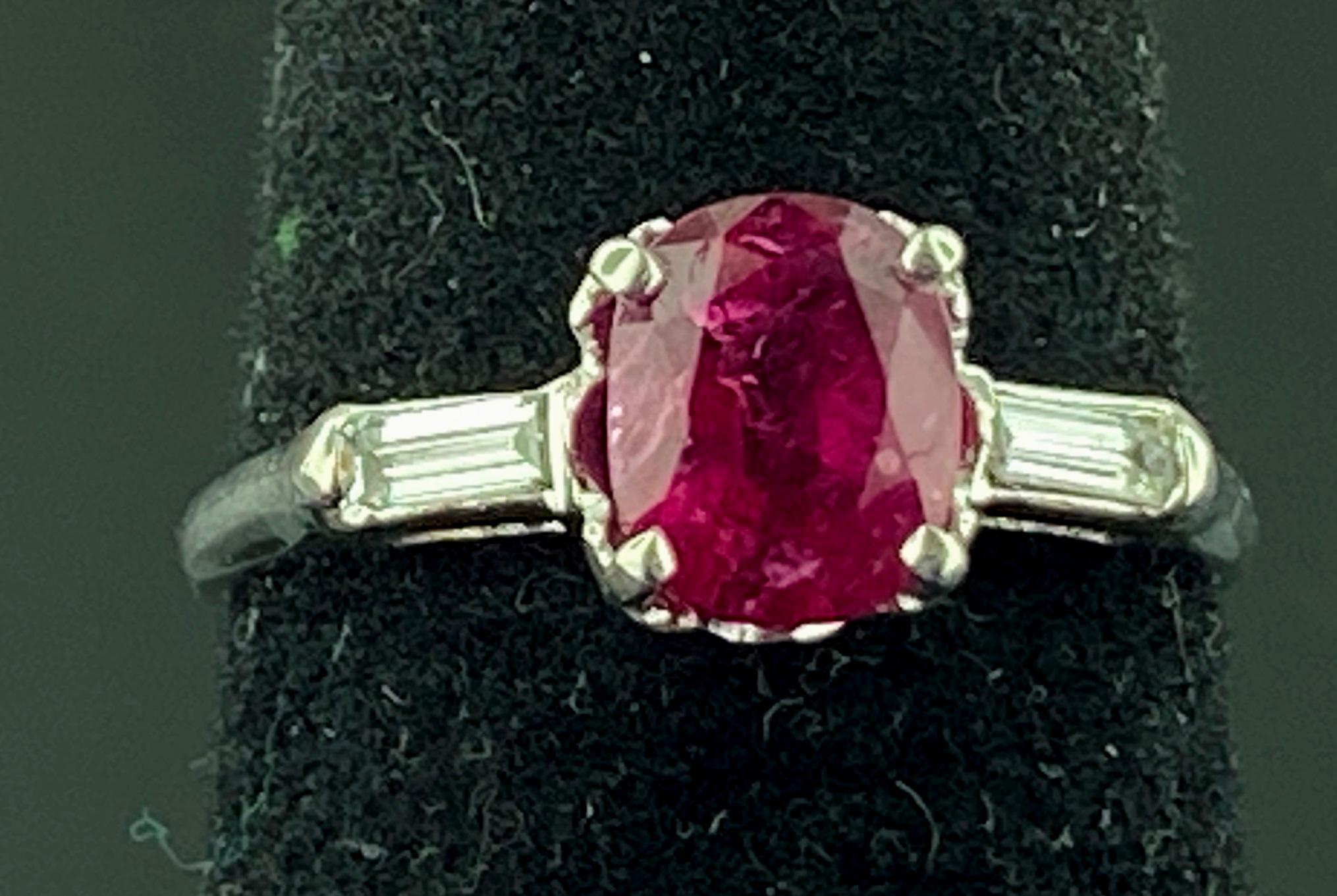 Set in Platinum is a 1.47 carat oval shaped Ruby center with two baguette cut diamonds on the sides with a total diamond weight of 0.10 carats.  Ring size is 6.5