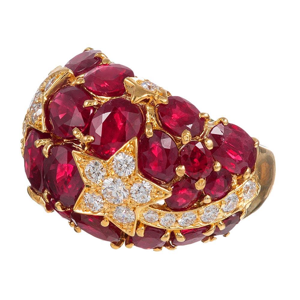 Intense red rubies are highlighted with twinkling shooting stars and peppered with brilliant white diamonds in this fun and unique creation. The ring is rendered in 18 karat yellow gold and accented with 11.40 carats of rubies and .83 carats of