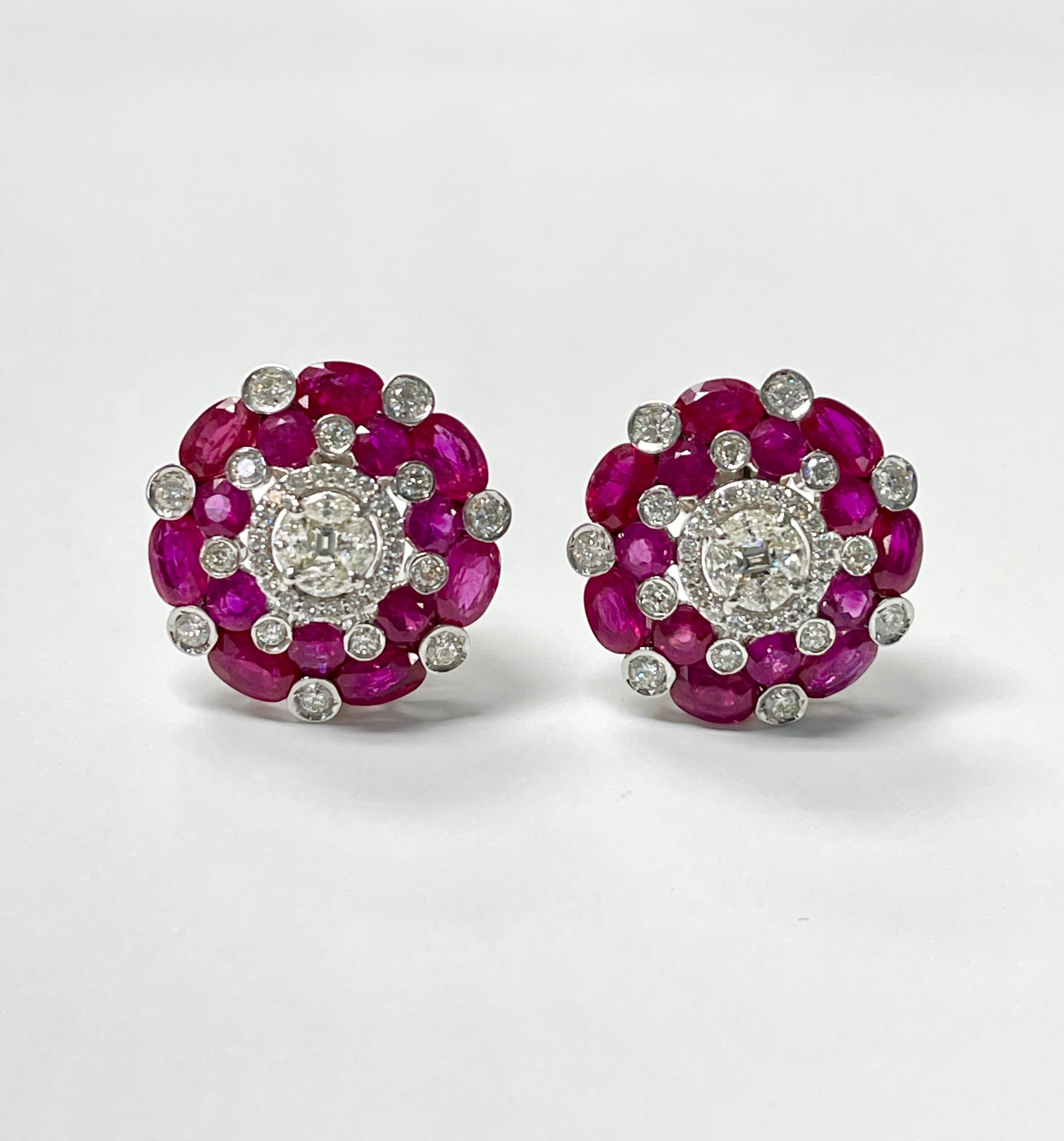 Natural Ruby and diamond stud earrings beautifully handcrafted in 14k white gold. 
The details are as follows : 
Ruby weight : 11.9 carats 
Diamond weight : 2.3 carats ( GH color and VS clarity ) 
Metal : 14k white gold 
Measurements : 23mm 

