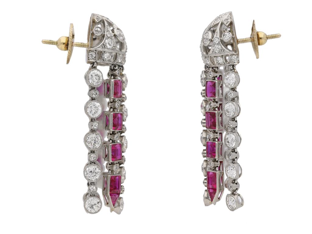 Ruby and diamond tassle earrings. A matching pair of earrings, each set with ten square and triangular step cut natural unenhanced rubies, all twenty in open back rubover settings with a combined approximate weight of 4.00 carats, further set with