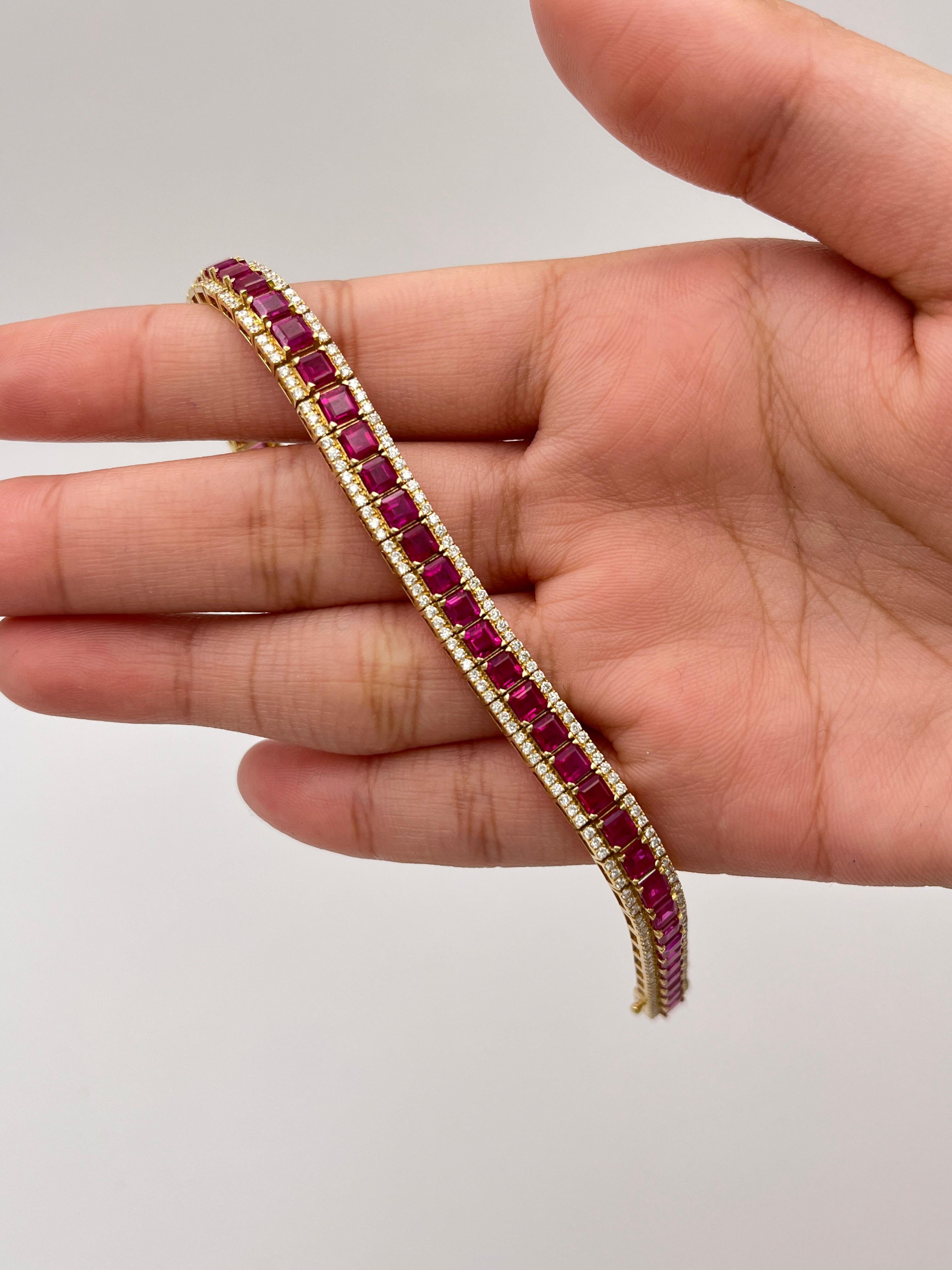 A timeless symbol of elegance, this ruby and diamond bracelet is masterfully crafted in 18K yellow gold. The design features a continuous line of square-cut rubies, each meticulously hand-set to create a seamless ribbon of vivid color. Surrounding