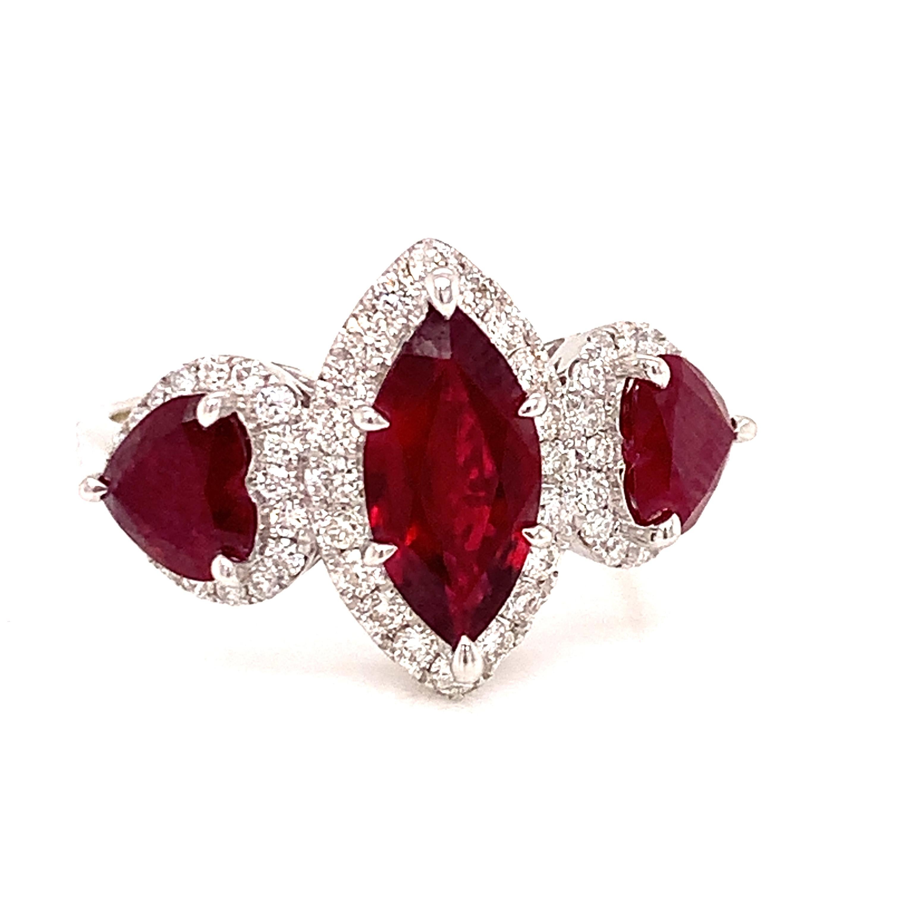 Old world craftsmanship with todays technology, this vintage inspired ring may be even better than Grandmas.   A stunning 1.15 carat marquis gem quality genuine ruby,  surrounded by 1.41 cttw in round diamonds and  1.08 cttw in 2 heart shaped