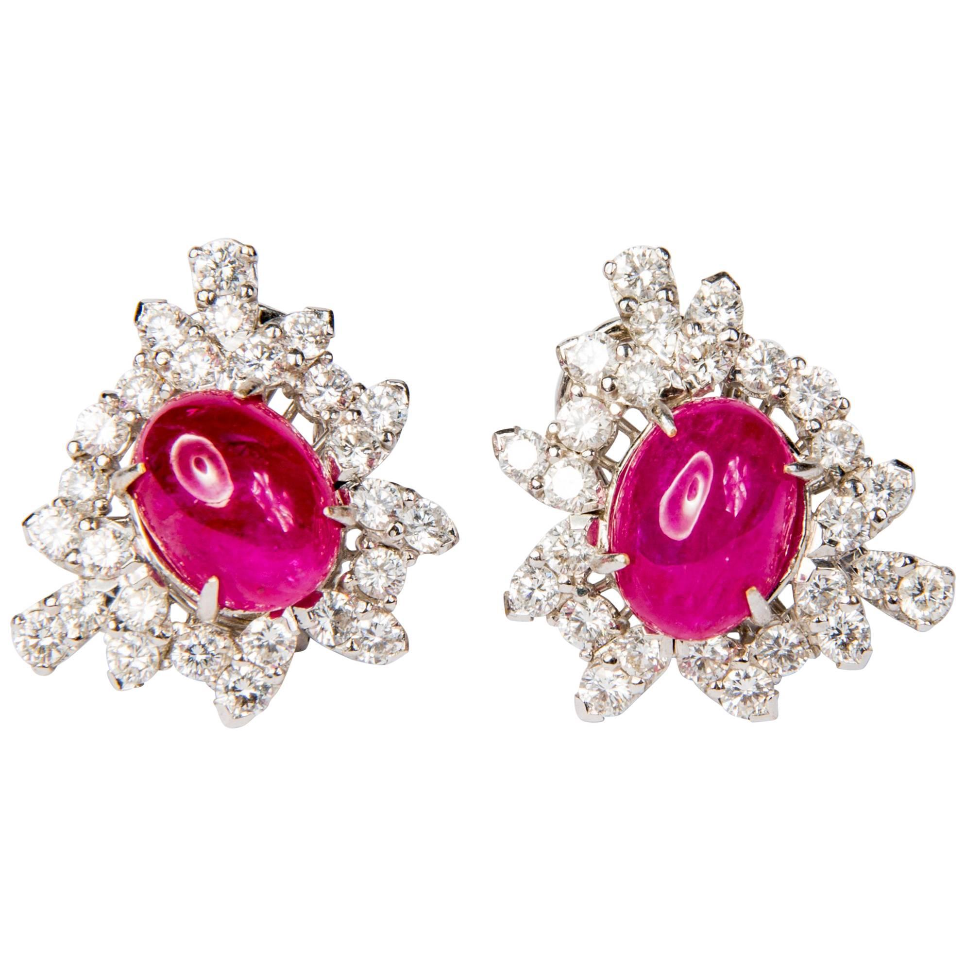These ruby and diamond earrings are elegant and versatile. 9.54ct ruby cabochons and 2.87ct diamonds are mounted in 18K white gold. Unique pair of handcrafted piece that will compliment your outfit perfectly.

They come with studs and clips, which