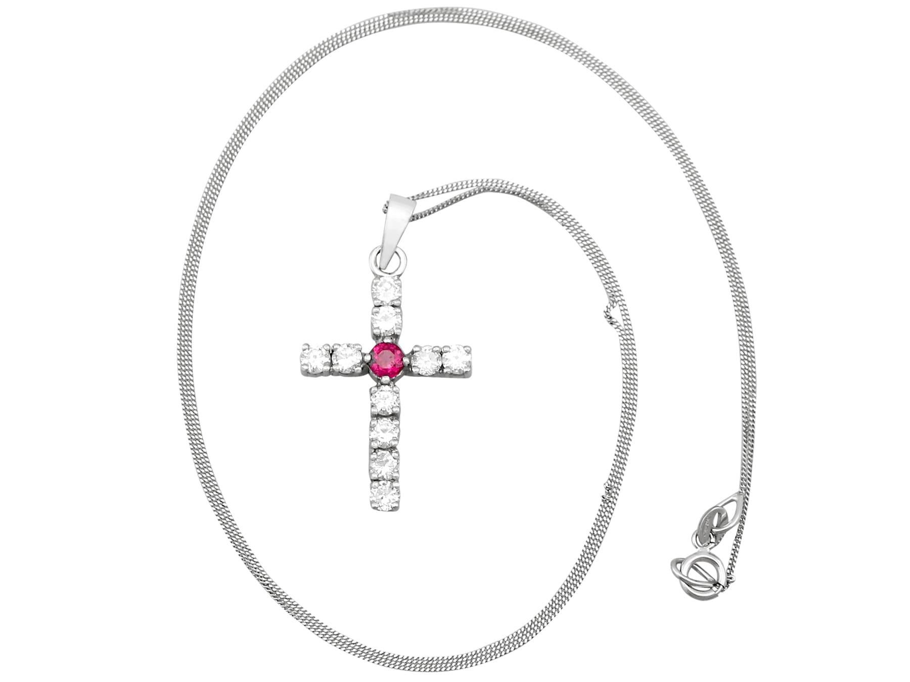 An impressive vintage 0.15 carat ruby and 0.85 carat diamond, 18 karat white gold 'cross' pendant; part of our diverse ruby jewelry and estate jewelry collections.

This fine and impressive vintage pendant has been crafted in 18k white gold.

The