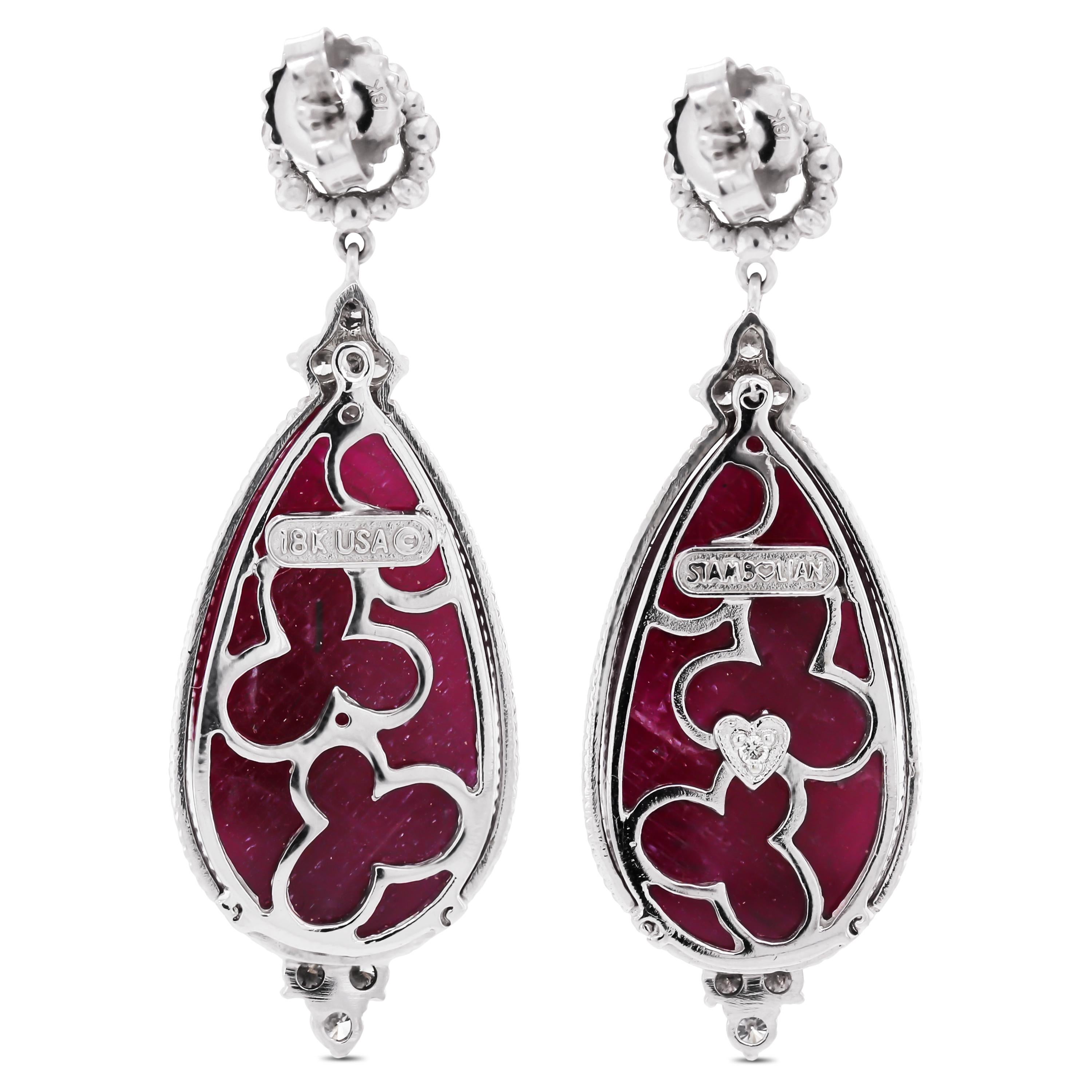 18K White Gold and Diamond Drop Earrings with Sliced Rubies by Stambolian

This pair of earrings showcases two pear shape sliced rubies in the center with a checkered cut design. 

Apprx. 38 carat Ruby total weight
1.65 carat G color, VS clarity