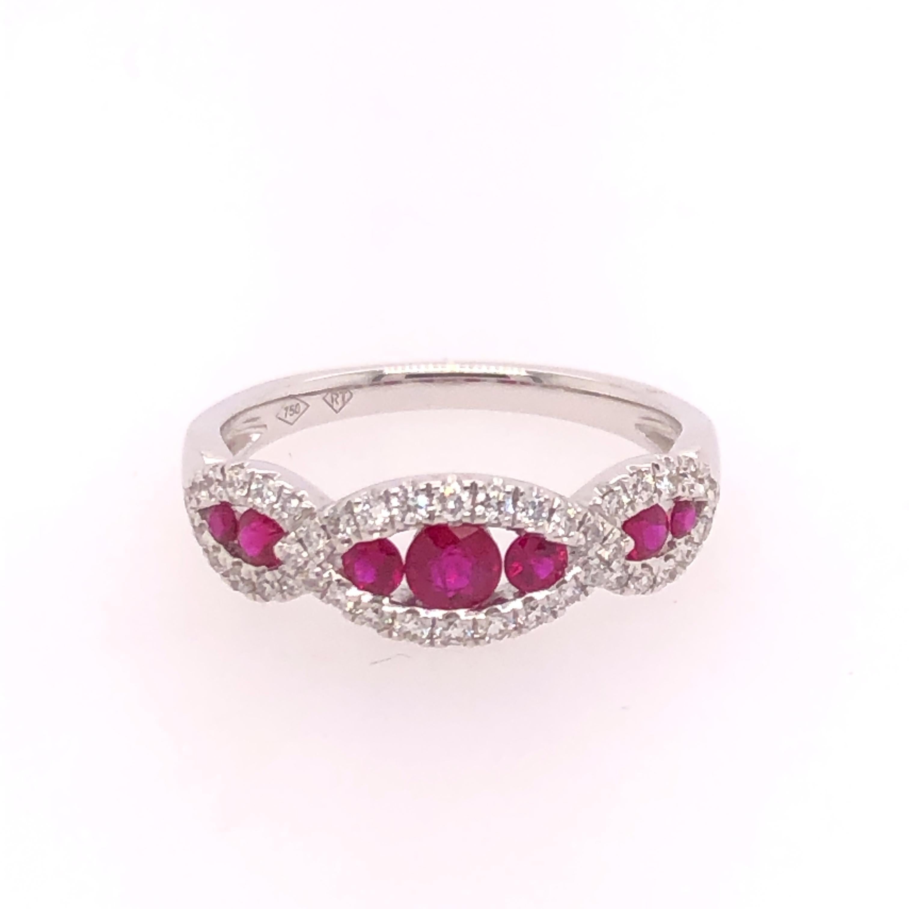 An elegant and fashionable marquise-like design allows this ruby and diamond ring to be an everyday ring. The 18K white gold mounting is set with 7 rubies of varying sizes (total carat weight of 0.46 CT) and 42 accent diamonds (total carat weight of