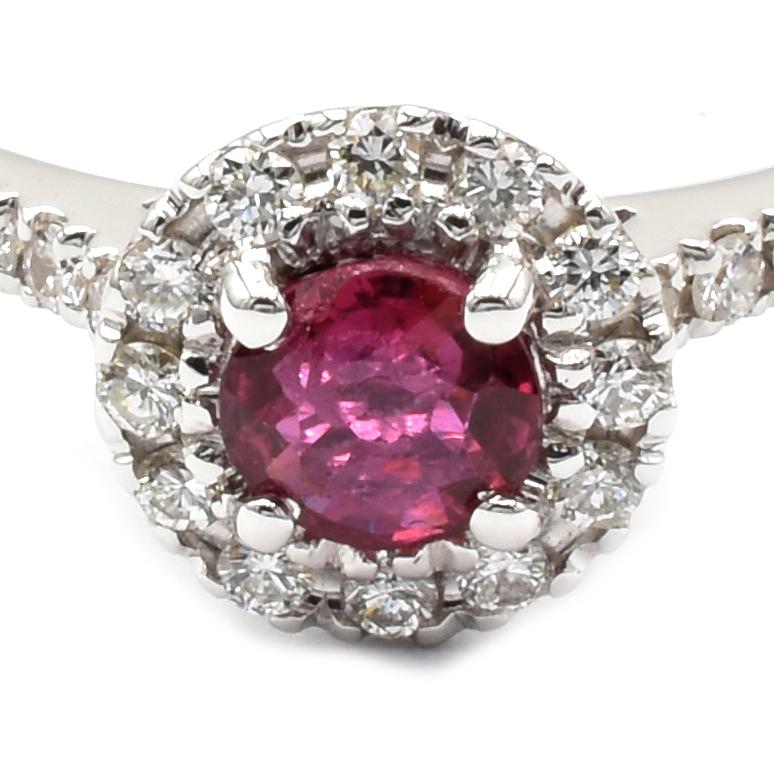 18Kt White Gold Ring with a Round Bright Red Ruby surrounded by small White Diamonds.
Handmade in Italy in Our Atelier in Valenza (AL)
18Kt Gold g 2.40
Ruby ct 0.38
Diamonds ct 0.16 
This Ring is sized E 54 (US 6 3/4) and can be shipped in any size