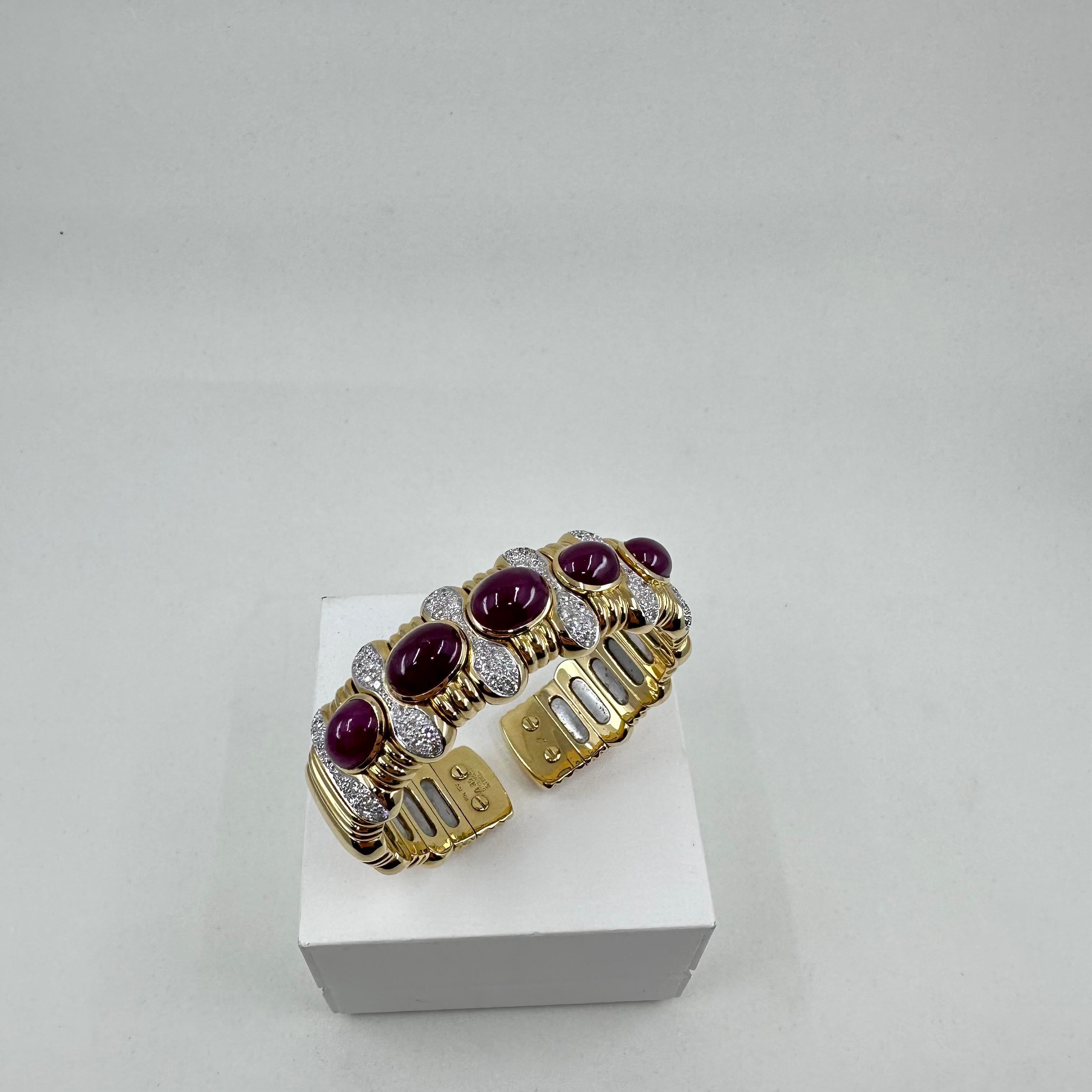 Substantial 18 karat yellow gold wide cuff bracelet containing five large cabochon rubies approximately 25 carats total weight and numerous white clean diamonds and 3.00 cts total weight of Round Diamonds 
Bracelet will fit a medium to large wrist