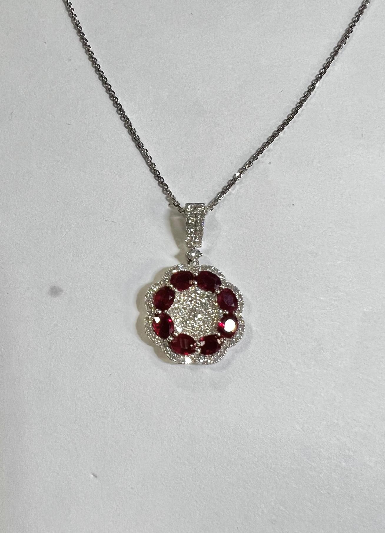 Ruby and Diamond Wreath Pendant 

Stones: Ruby  
Stone Shape: Oval 
Stone Carat: 1.50 Carat 
Side Stones: 76 Diamonds 
Stone Shape: Round Diamonds
Stone Weight: 0.67 Carat 
Material: 18K Yellow Gold 
Chain: Diamond Cut Link Chain with Lobster Clasp