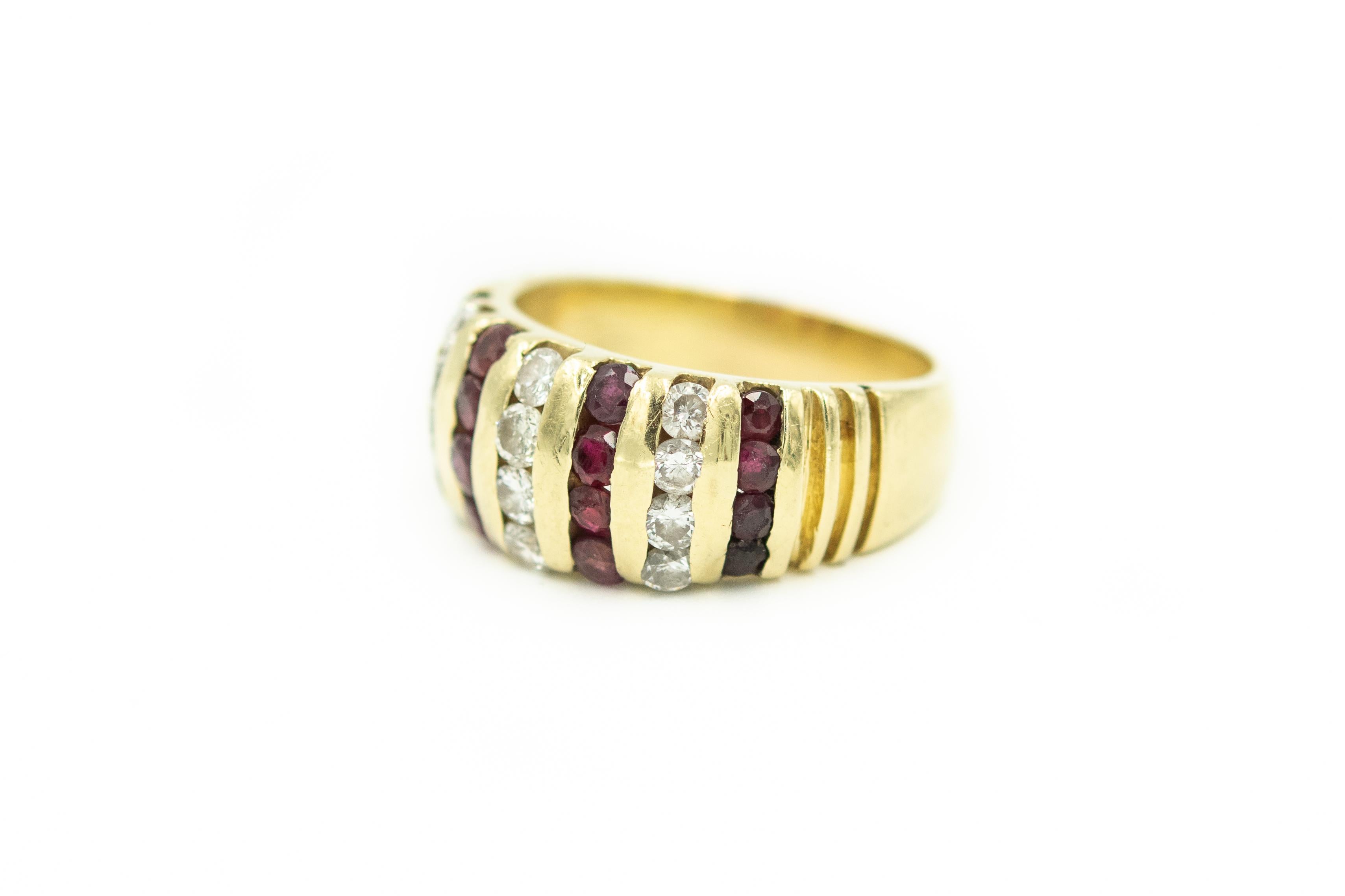 Stunning dome ring features alternating rows of channel set rubies and diamonds.  There are 4 rows that contain 4 faceted round rubies each that measure approximately 2mm each and 3 rows that contain 4  round diamonds that weight approximately. .02