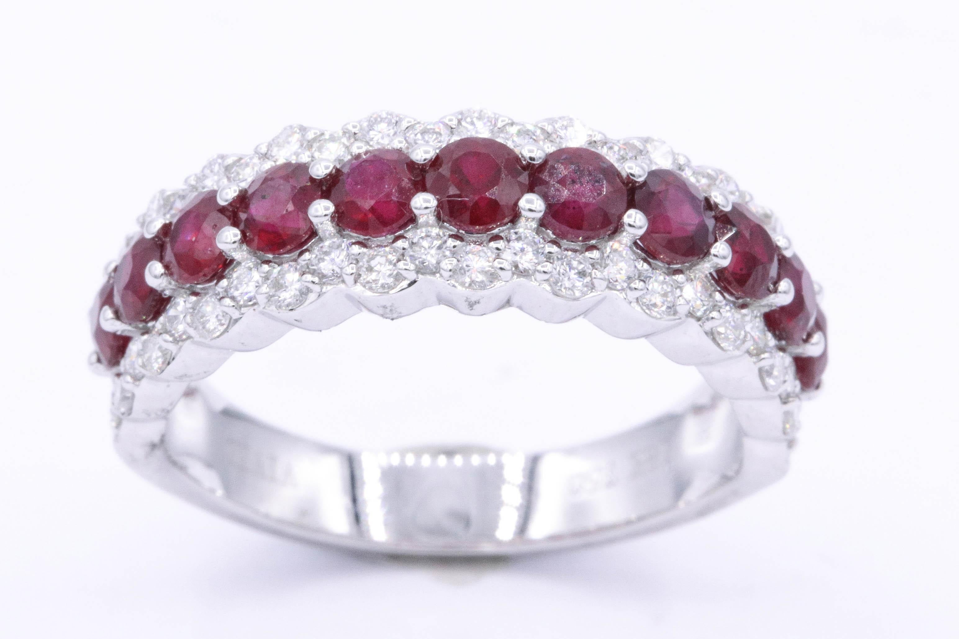 18k White gold wedding band featuring 11 red round Rubies weighing 1.10 Carats flanked with 50 round diamonds weighing 0.60 carats. Color G-H Clarity SI
6.25 mm width 