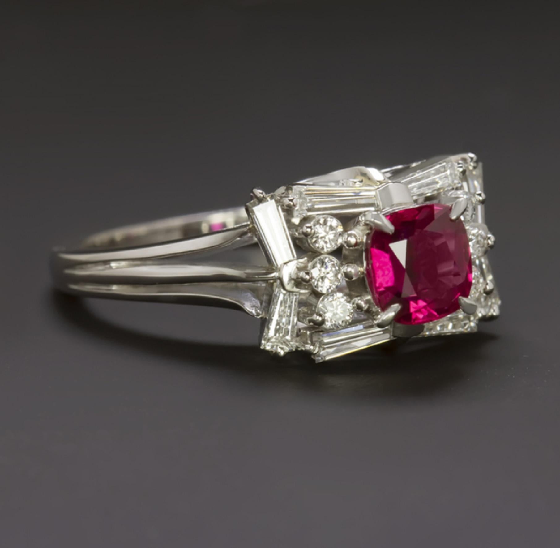 Striking and high quality, this ring has an air of glamour and luxury! The round ruby center stone weighs 1.12cts and is beautiful in color with a rich true red hue. The ruby is translucent, allowing light to pass through and making it particularly