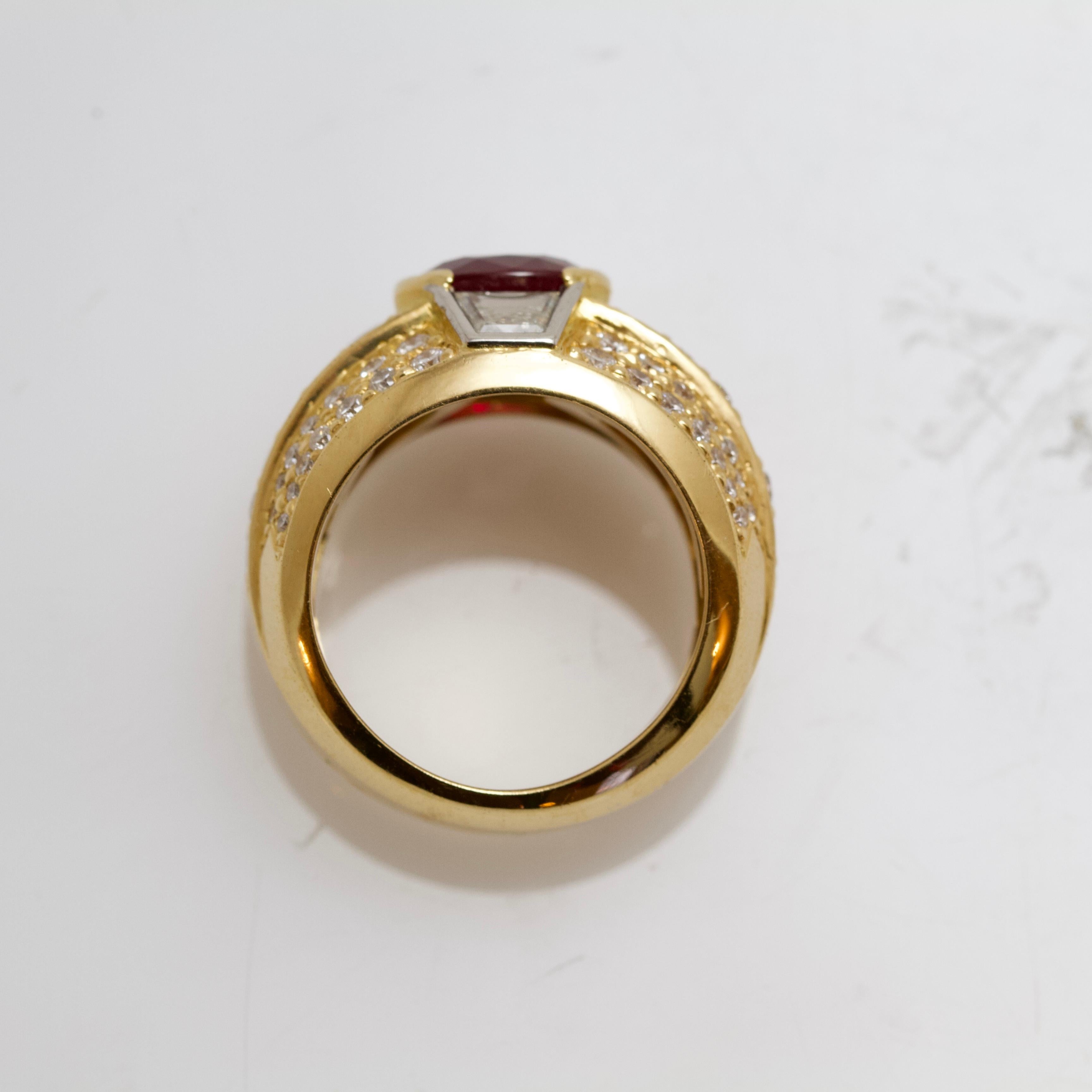 18kt yellow gold ring or signet ring set with rounds and baguette cut diamants and centered with a rubis weighting around 2 carats.
Made probably around 1990. 
Ruby's quality natural and nice red color.
French assays marks for 18kt gold. 
French