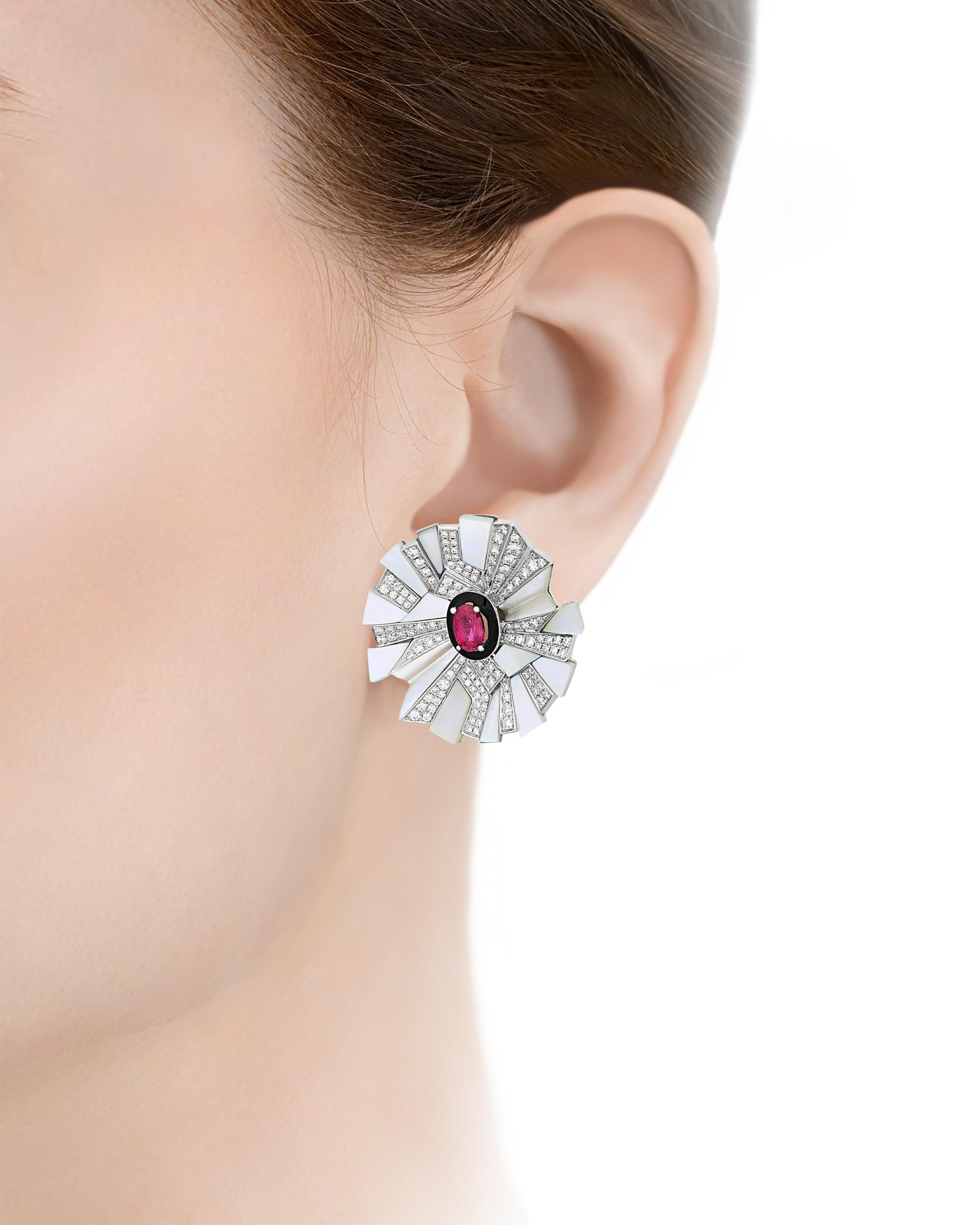 The exquisite rubies at the heart of these captivating earrings hail from Mozambique and total 1.12 carats. Rubies from this region are highly sought after for their brilliant red hue and high transparency. These incredible stones are surrounded by