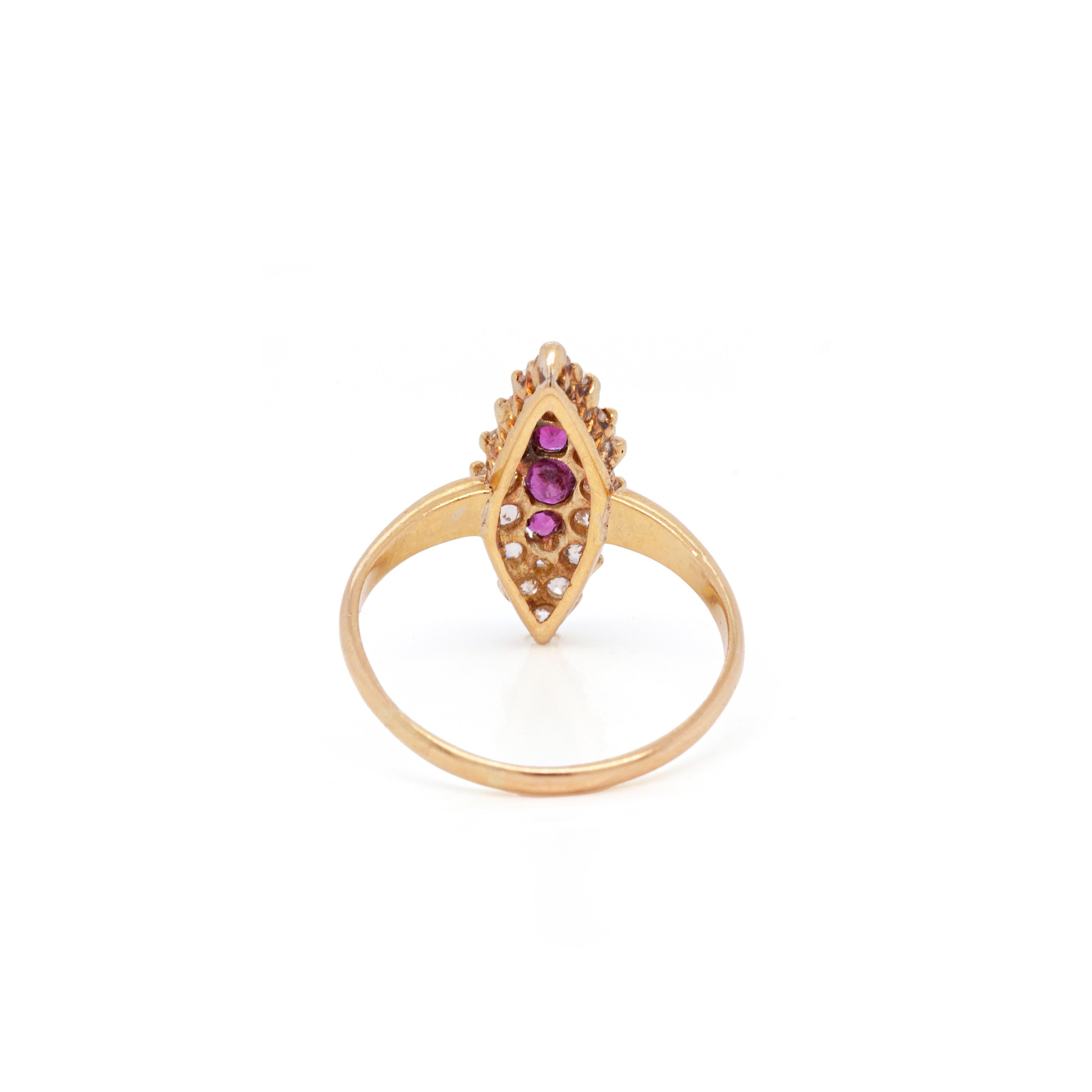 This wonderful antique marquise shaped 18 carat yellow gold ring features 3 lively red round rubies vertically set in the centre, weighing approximately 0.20ct combined. To add extra sparkle, the rubies are beautifully surrounded by 16 old cut