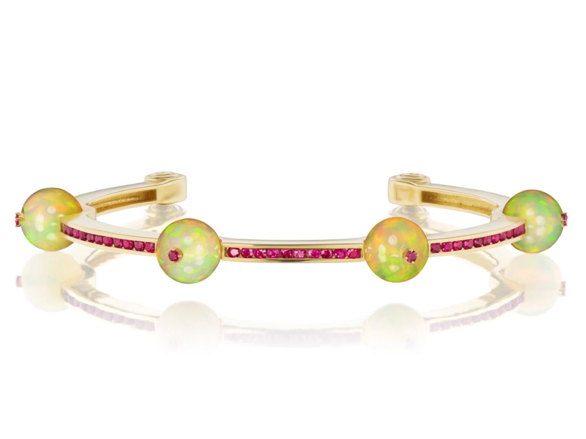 34.5 carats of vibrant African opals with a spectacular play-of-color make up this new bracelet by Andrew Glassford. They are 8.5mm round opals and the bracelet is part of his Booster series. It contains 1.35 carats of round brilliant rubies and is