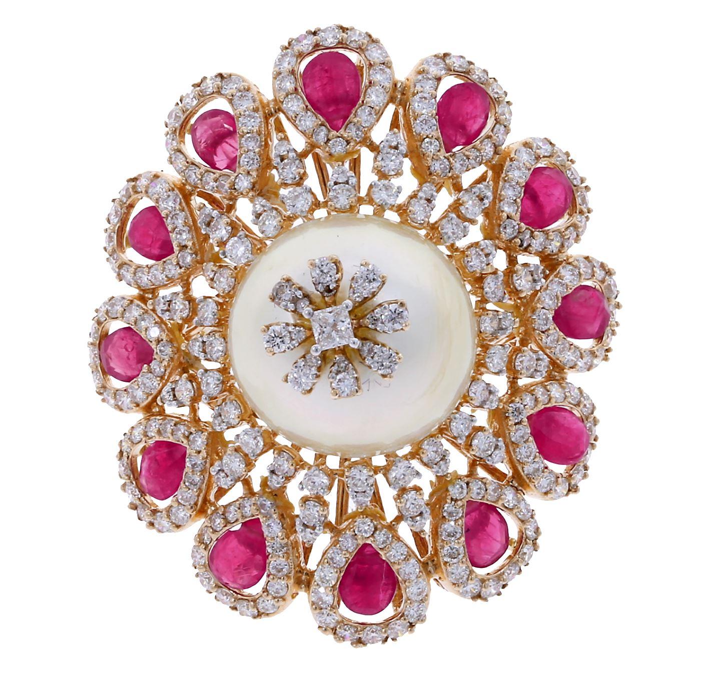 A bold, high-dome cocktail ring consisting of a large 18 ct. Pearl elevated in the center, accented with Diamonds on the surface and all around, with ruby petals circling the bottom. Diamonds (2.03 cts), Ruby (2.05 cts). 18K Yellow Gold.