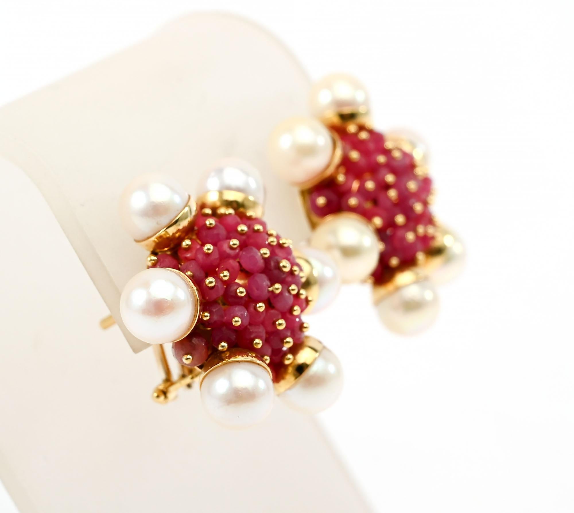 Clusters of rubies are surrounded by 6 cultured pearls in these festive 18 karat earrings. Omega backs. Signed with a name that looks like Zancan but with which I am not familiar.