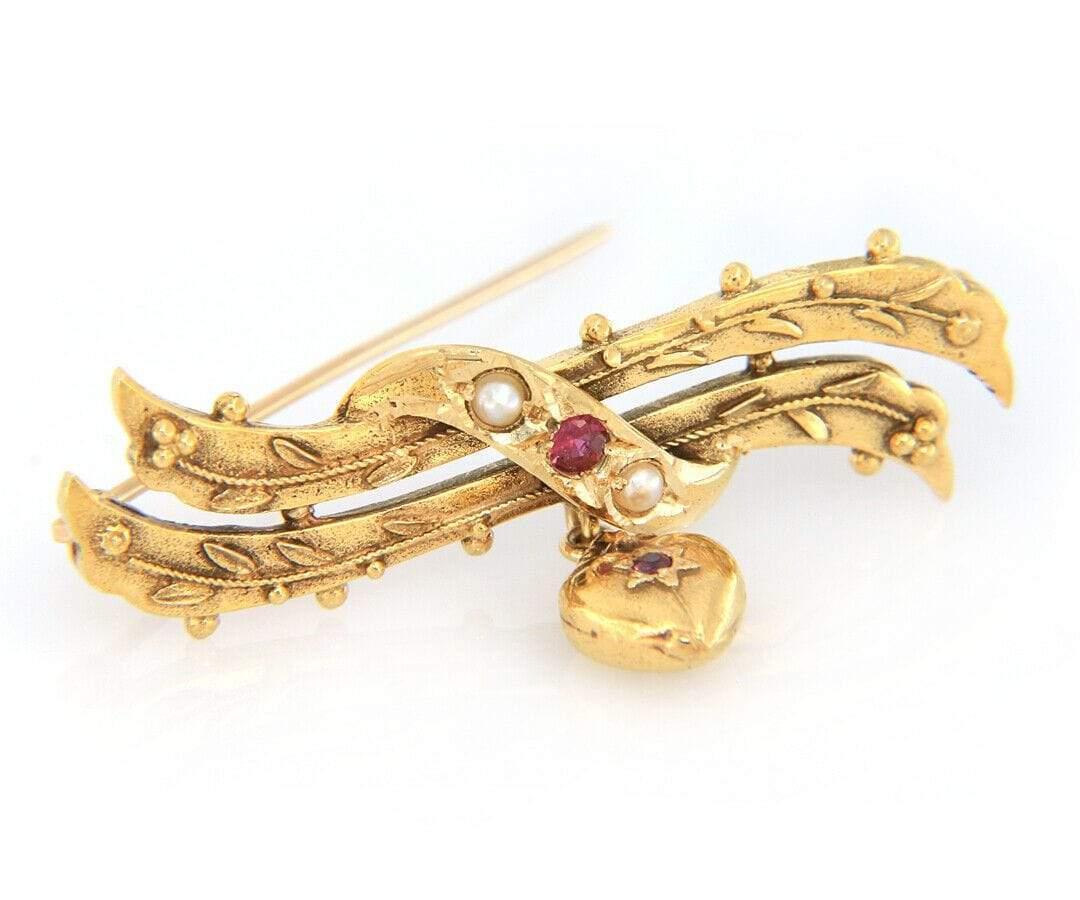 Ruby and Pearl Heart Dangle Brooch in 14K

Ruby and Pearl Heart Dangle Brooch
14K Yellow Gold
Brooch Width: Approx. 9.0 MM
Brooch Length: Approx. 44.0 MM
Weight: Approx. 5.50 Grams
Stamped: 14K

Condition:
Offered for your consideration is a