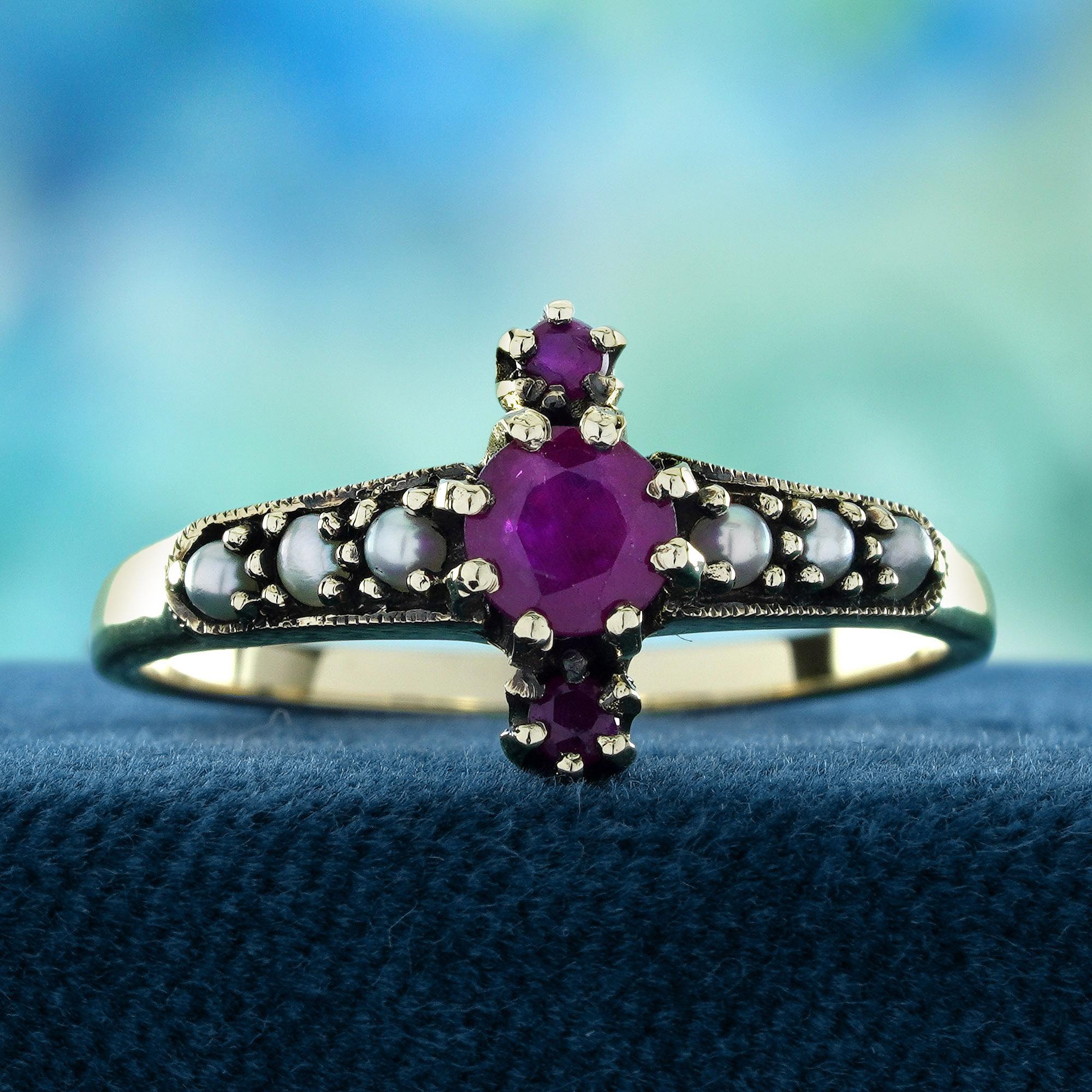 A stunning round ruby at the center, flanked by additional rubies on the top and bottom. The shoulders of the ring are adorned with lustrous pearls, adding a touch of classic sophistication. The combination of vibrant rubies and delicate pearls