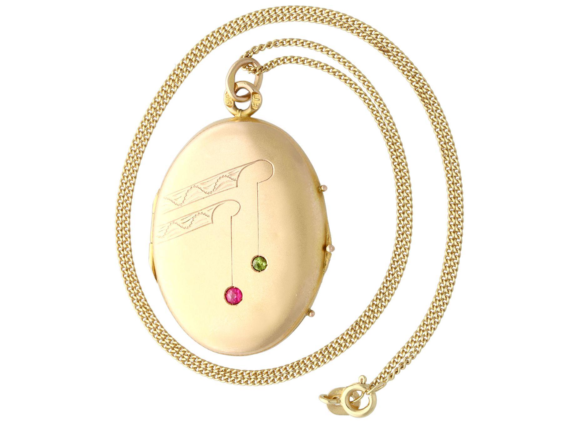 A fine and impressive antique Russian 0.10 carat ruby and 0.06 carat peridot, 14 karat yellow gold locket; part of our diverse antique estate jewelry collections.

This fine and impressive antique locket has been crafted in 14k yellow gold.

The