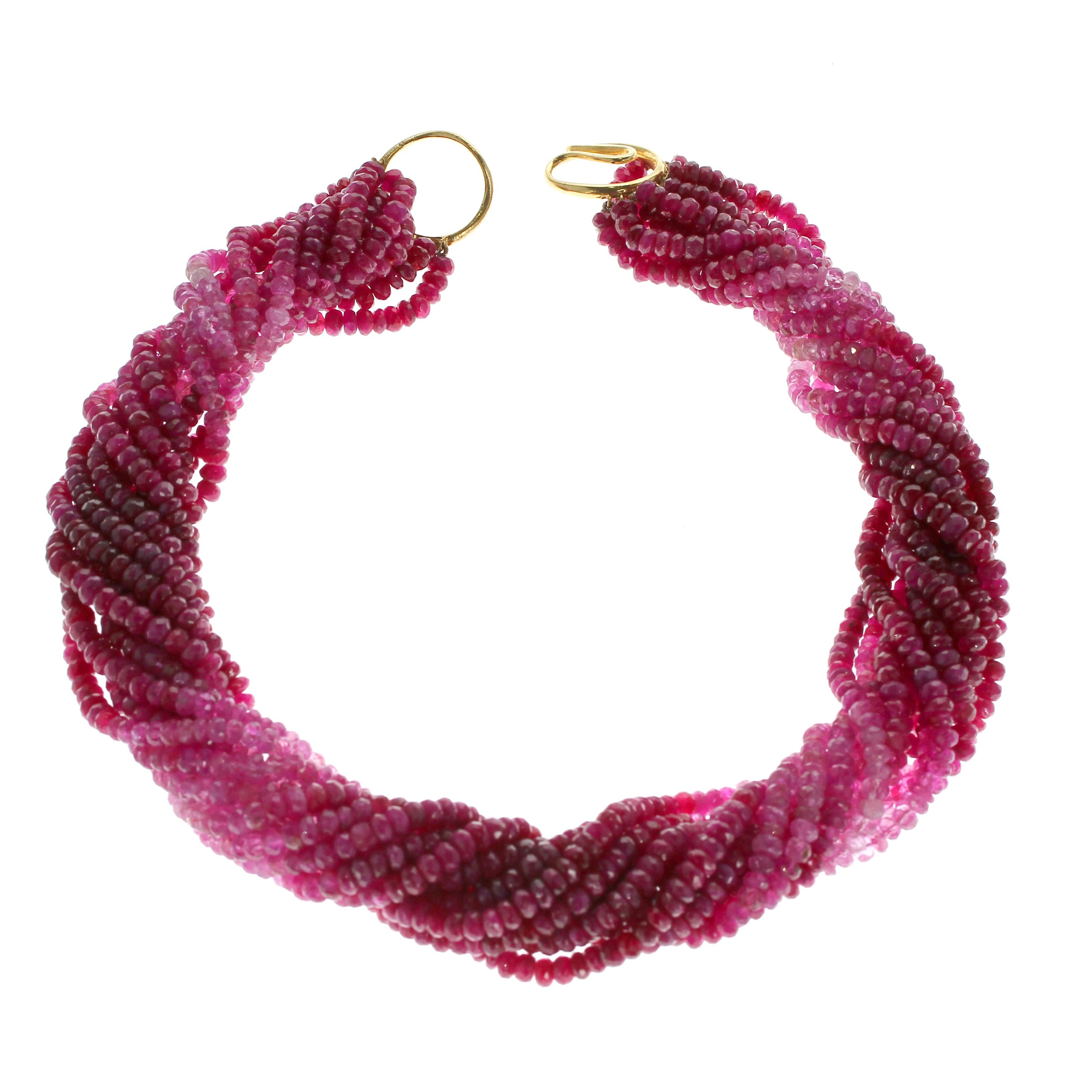 A ruby and pink sapphire bead necklace with an 18kt yellow gold clasp; the total weight of the necklace is approximately 988 carats, length 17.25 in.