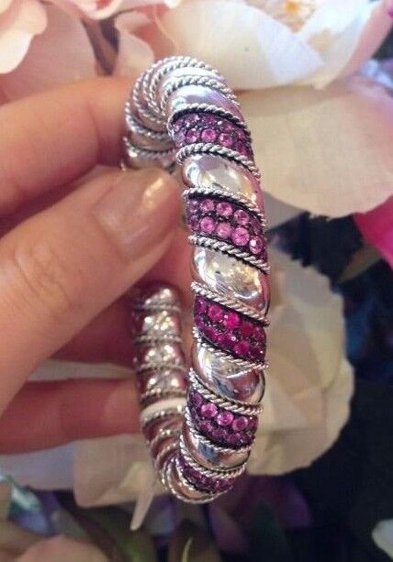 Ruby and Pink Sapphire Cuff Bangle Bracelet 3.00 carat total weight in 18K White Gold

Italian made Ruby and Sapphire Cuff Bangle features a Twisted Rope design with 5 Pavé sections with 12 Red Rubies and 48 Pink Sapphires set in high-polished 18k