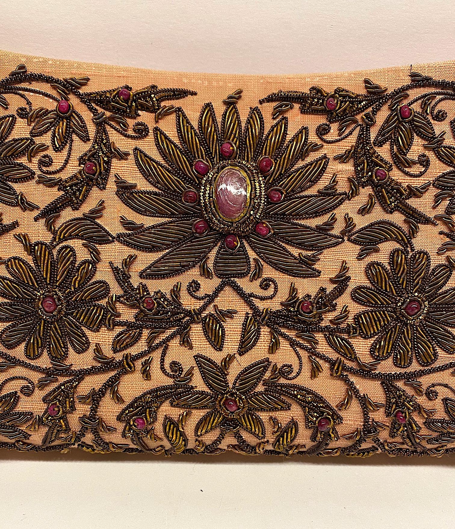 A beautiful and intricate hand embroidered evening bag from India. The use of gold and silver thread and precious jewels in embroidery is known as Zardozi and was once used to embellish the attire of the Kings and the royals in India. A pale pink