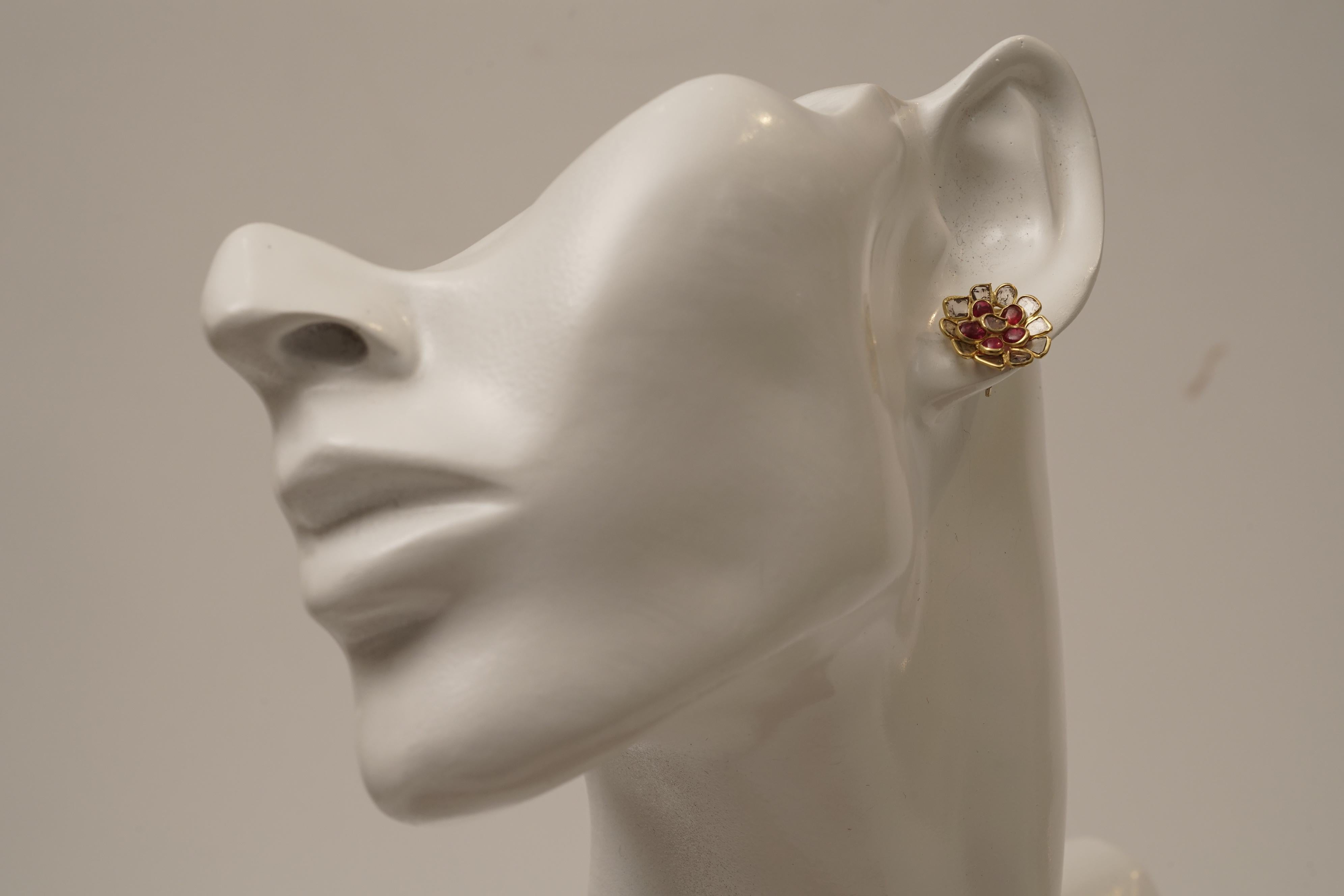 In a flower motif, cabochon rubies and rose cut diamonds comprise the petals of these stud earrings.  All set in 22K gold, for pierced ears.  Not your typical stud earring.  Rose cut diamonds are intentionally irregular, just enough facets to