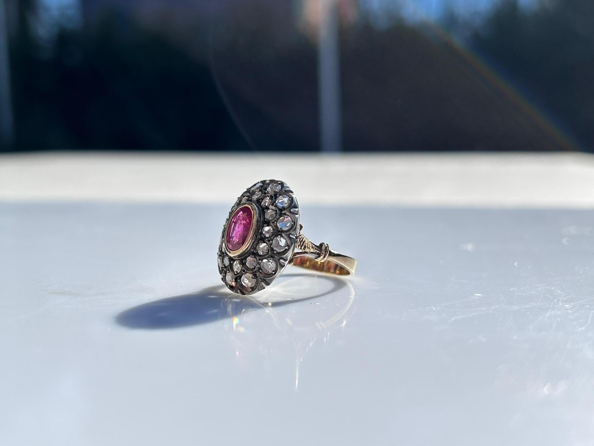 Antique dome ring made in 18 Kt yellow gold and 800 silver.
This vintage ring dates early 1900s. 
Ring has been left in its antique condition.
The oval cut Ruby measures approximately mm 8x6 ( 0.31x0.23 in ) and it is embellished by 24 rose-cut
