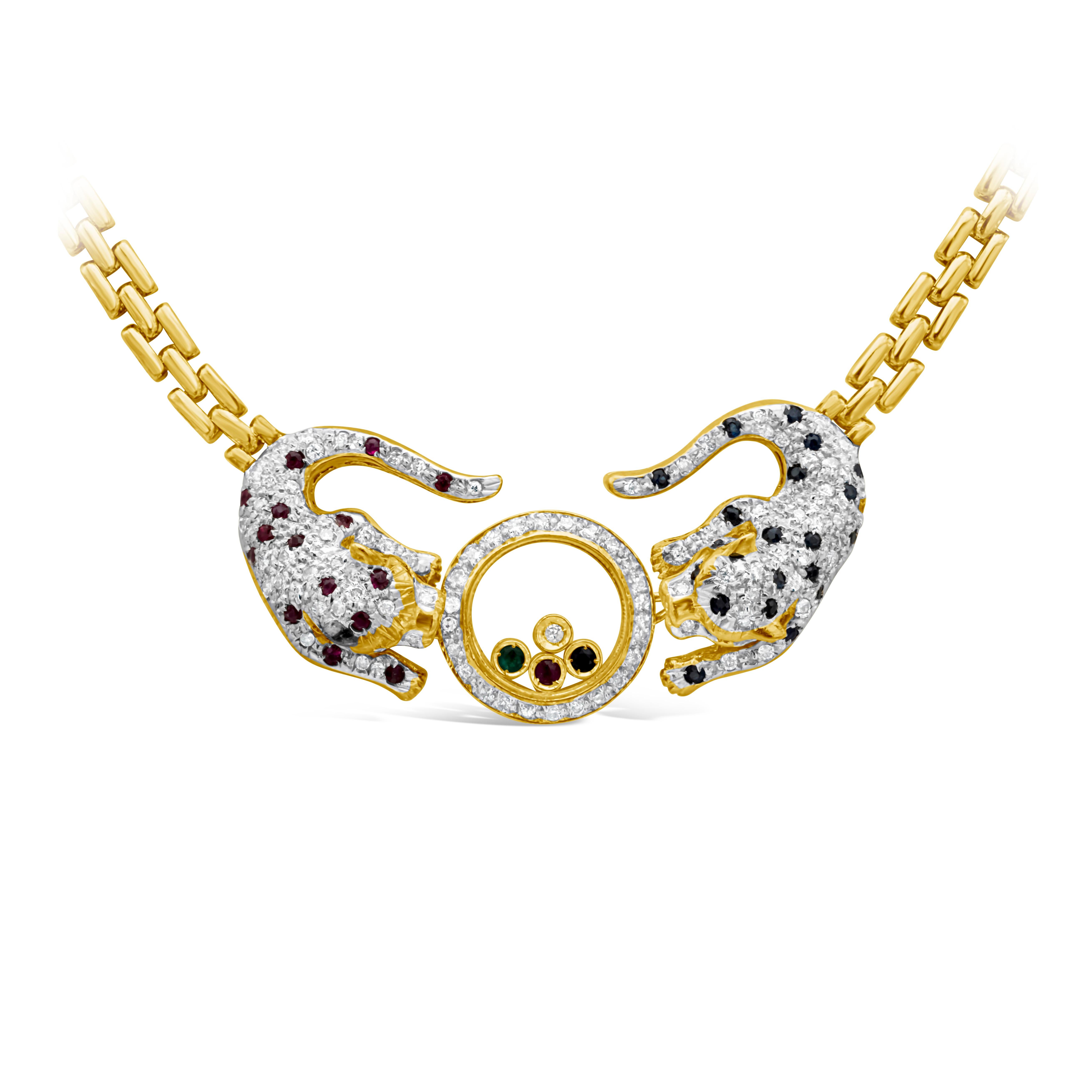 A artistic and luxurious gold link necklace featuring two perfectly matched jaguar encrusted with round brilliant diamonds, ruby and sapphires, with glass encased in the middle featuring mixed gemstones, bezel set, surrounded by a row of round