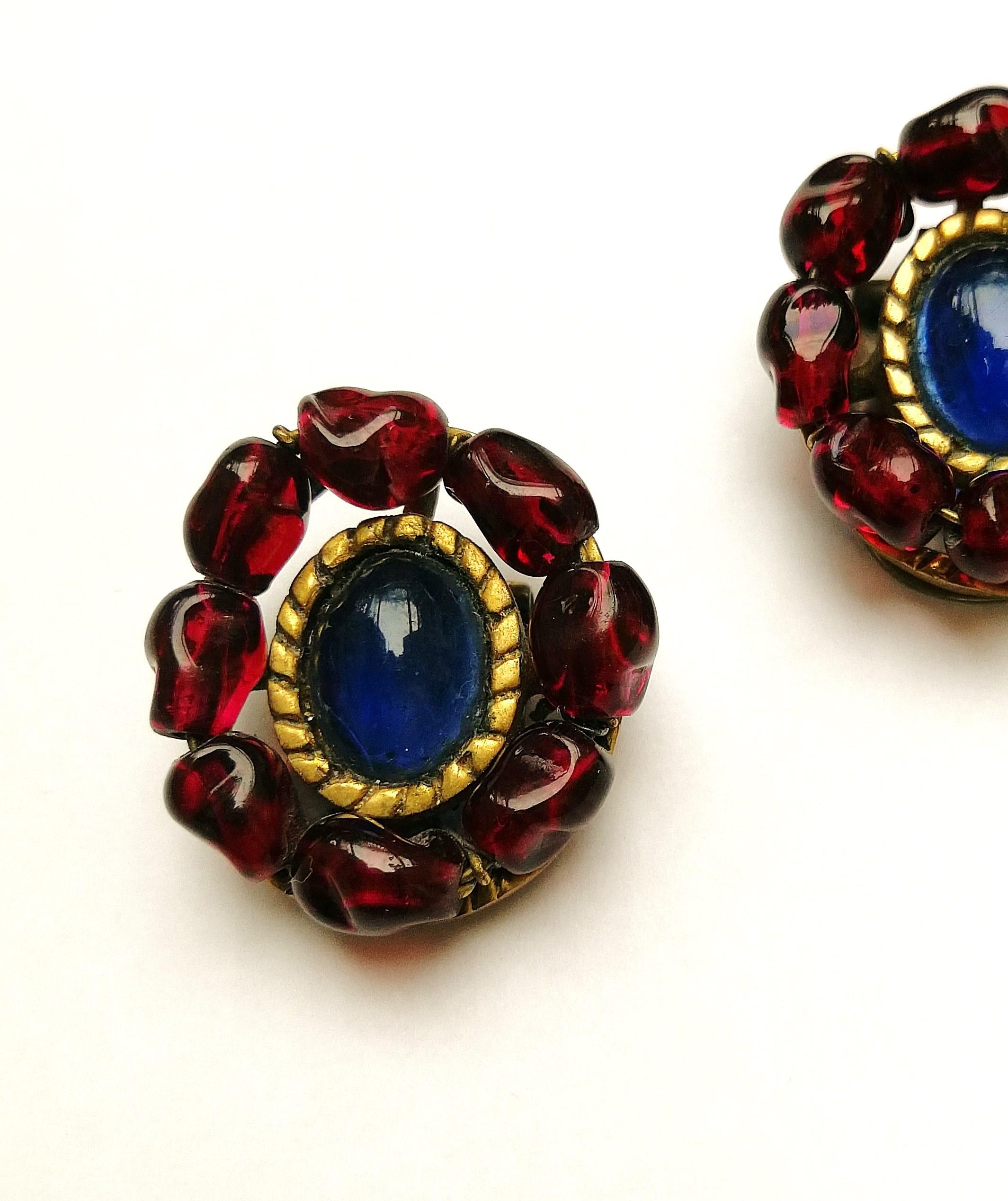 Classic in colouring and design, these unsigned earrings, attributed to Maison Gripoix in Paris , for Chanel, have hand wired 'ruby' poured glass beads encircling a rich 'sapphire' poured glass cabuchon, all set and attached to a gilt frame/earring.