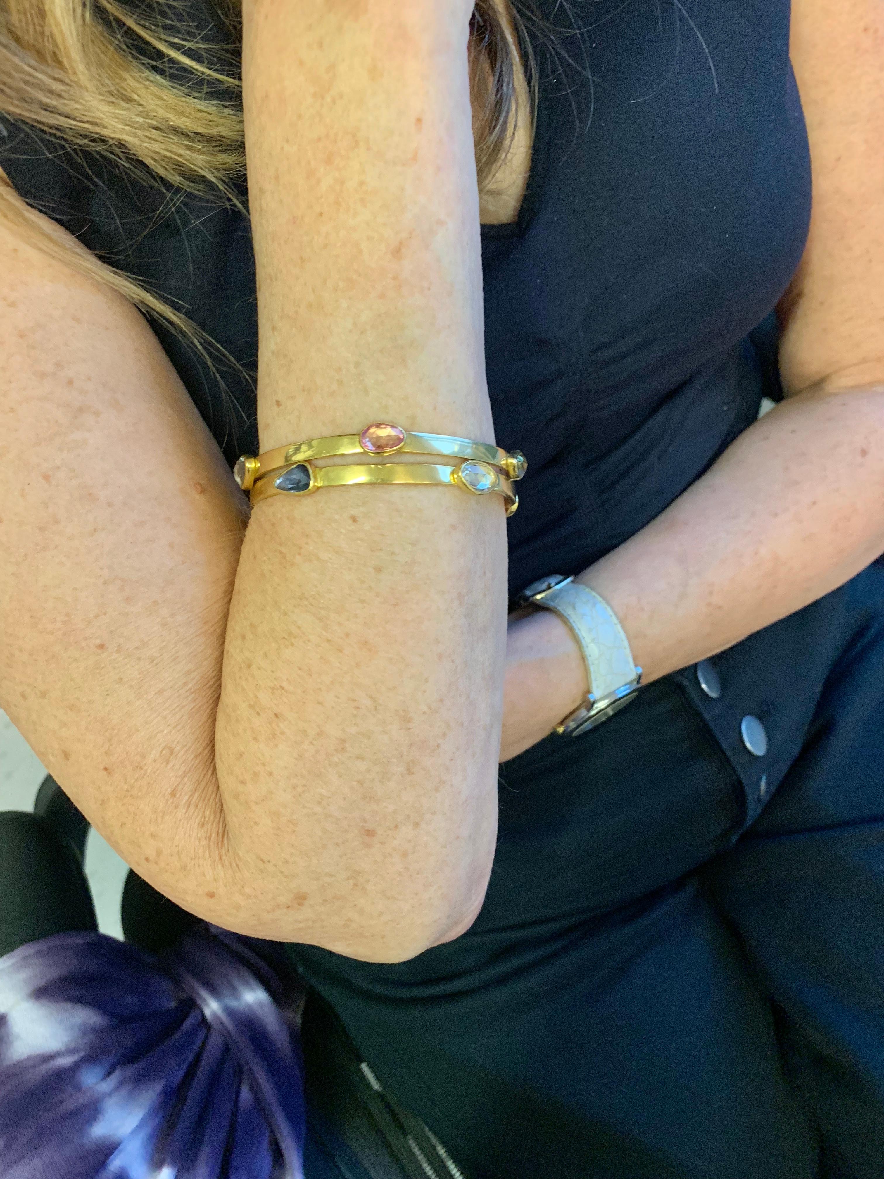 2 Bangle bracelets in 22 Karat gold set with multi colored rose cut Sapphires & 1 Ruby.  weighing individually  9.30 carats for the all Sapphire bangle and 9.70 carats for the bangle with Ruby.
Each bracelet weighing 32 grams or 1 troy ounce.
These