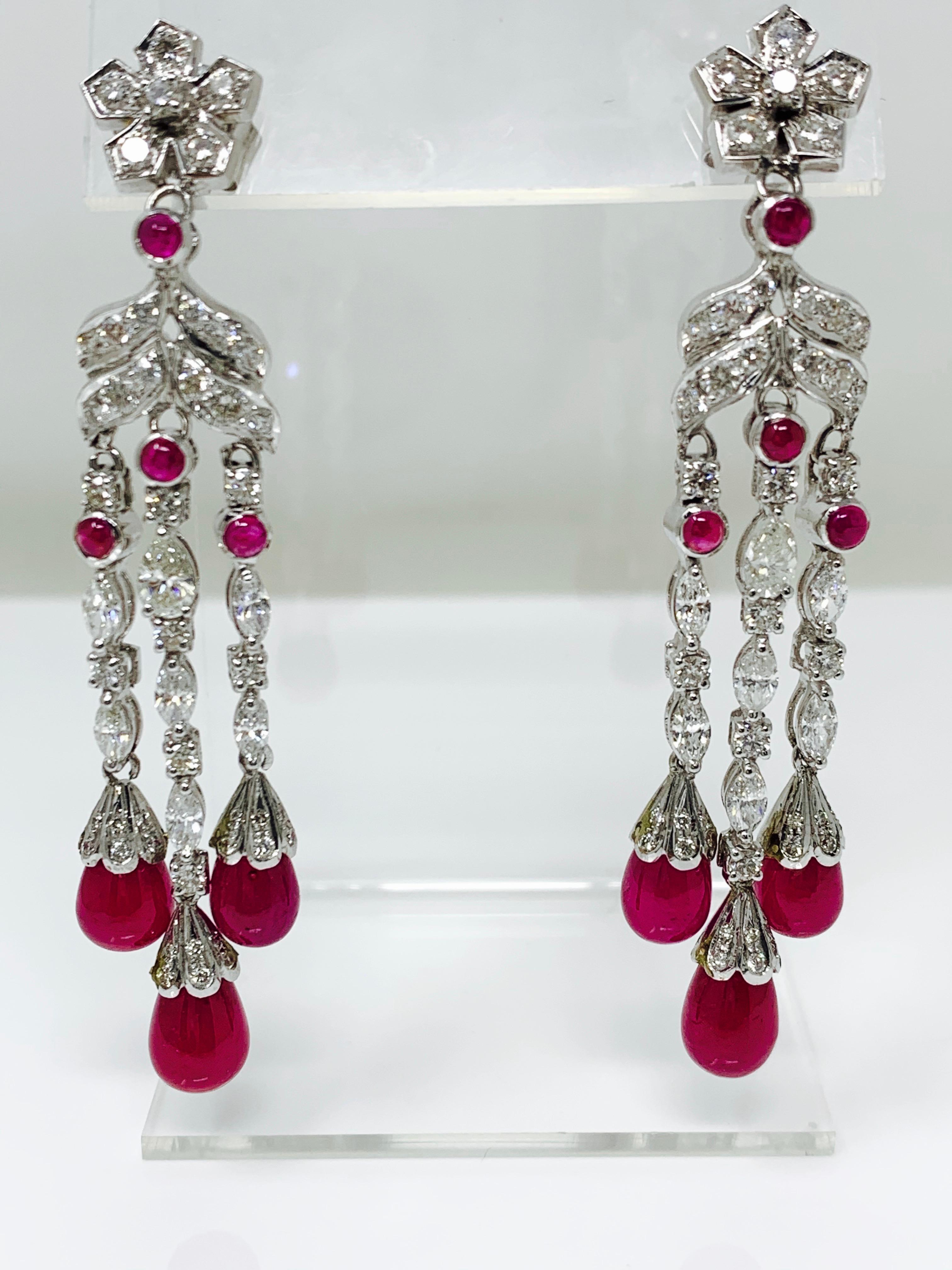 Moguldiam Inc Ruby and white diamond chandelier earrings are hand crafted In 18K white gold. 

Ruby cabochon weight : 1.22 carat 
Ruby drops weight : 25.52 carat 
Diamond weight : 4.84 carat 
Gold Weight : 7.484 grams 
 
