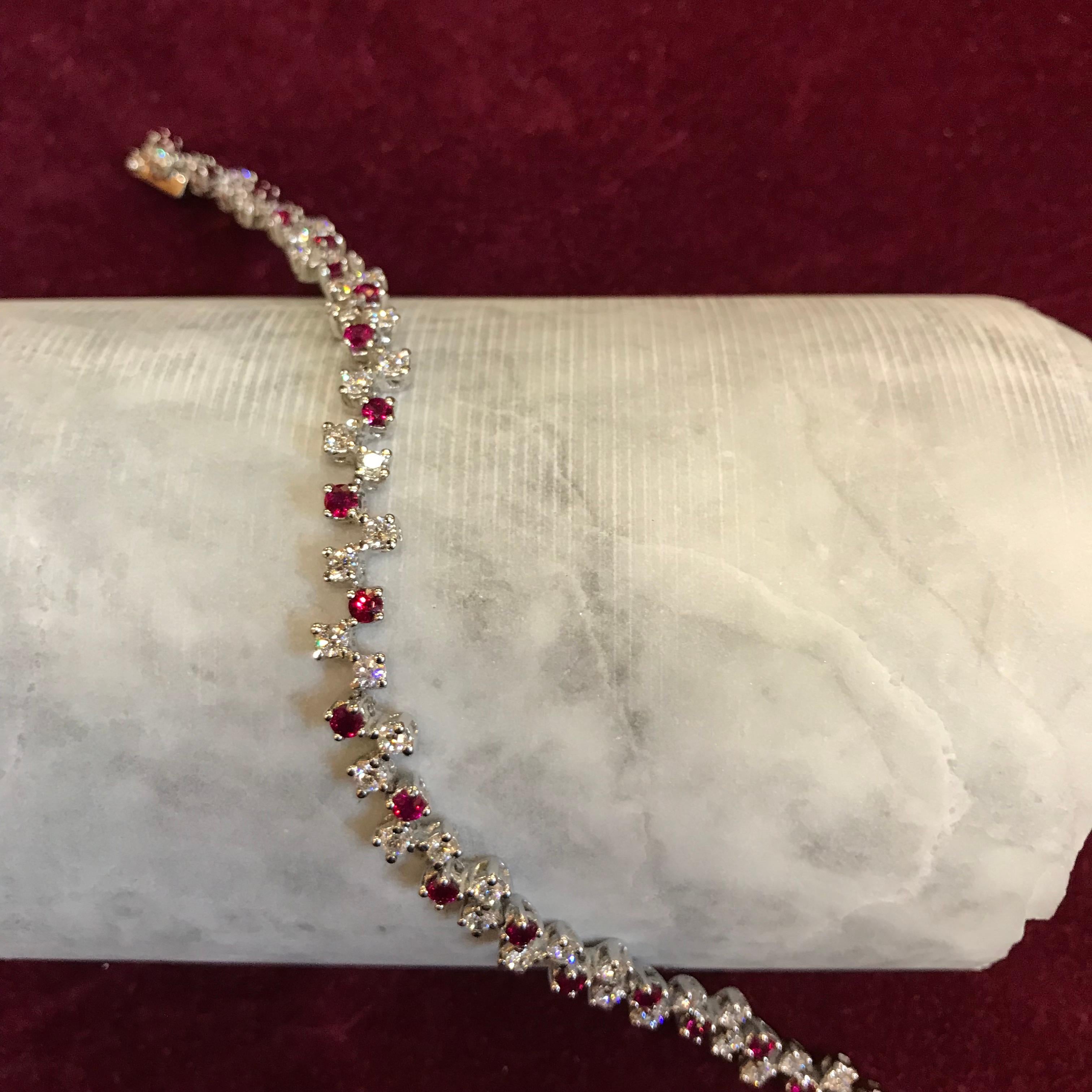 A modern take on the classic Diamond Tennis bracelet and with a little pop of colour. Handmade in our Italian workshop by a fifth generation goldsmith, 23 White VVS-F Diamonds and 21 Rubies are set in 18kt White Gold. The double clasp means that is