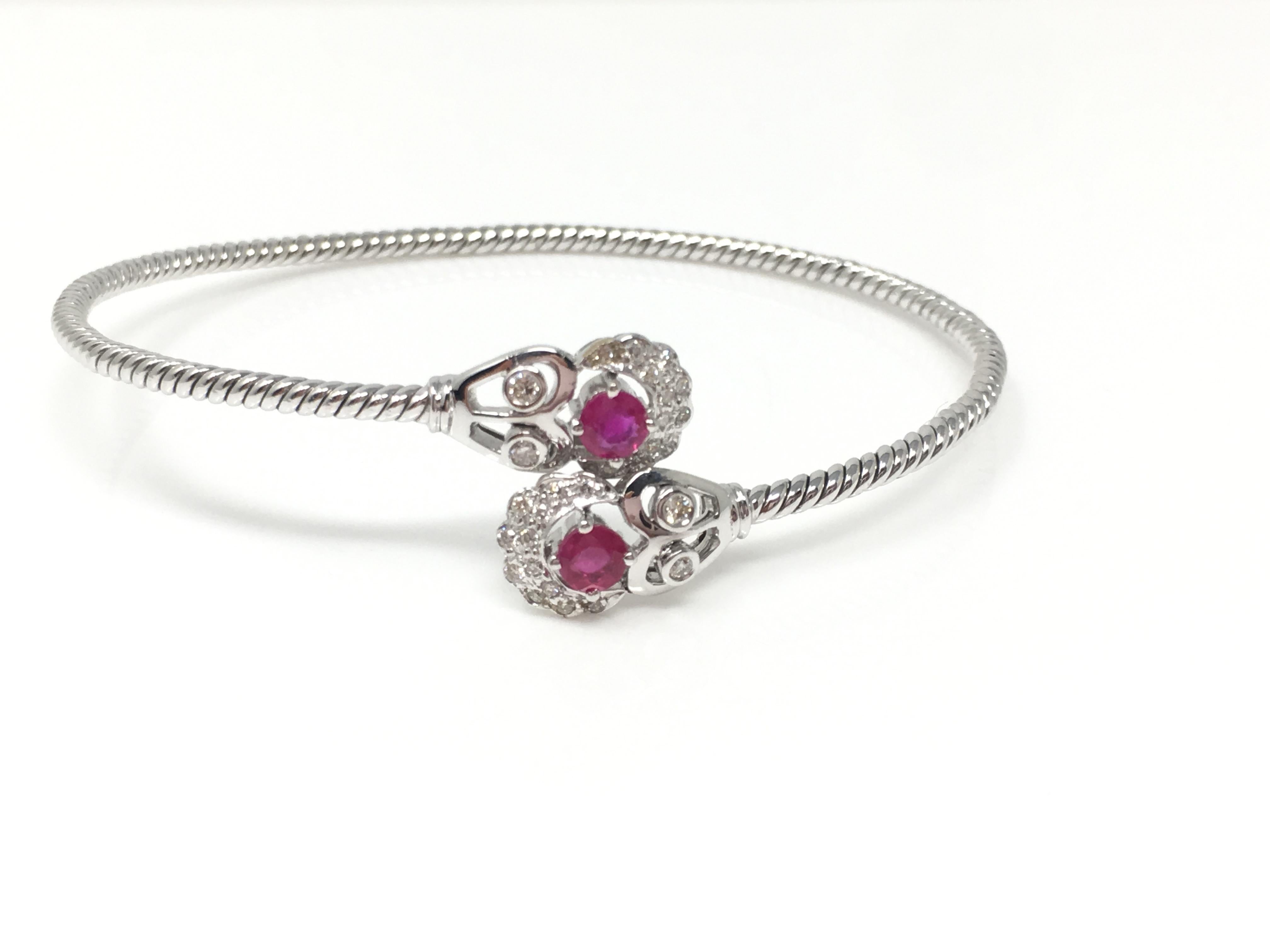 This elegant , stylish and trendy bangle is custom handmade in 18k white gold. The diamond weighs 0.17 carat with GH color and VS clarity and the ruby weighs 0.44 carat . The gold weight is 9.700 grams. The size of the bangle is flexible and